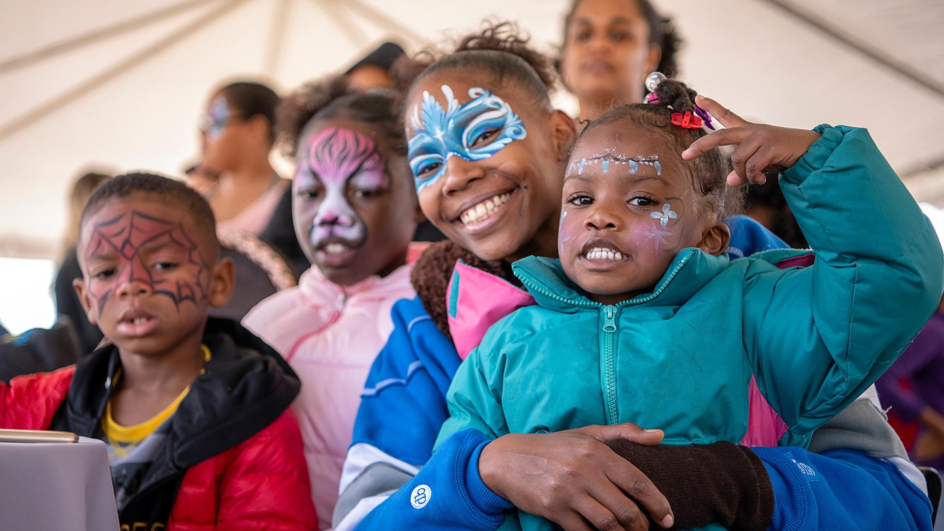 Kids with painted faces smiling