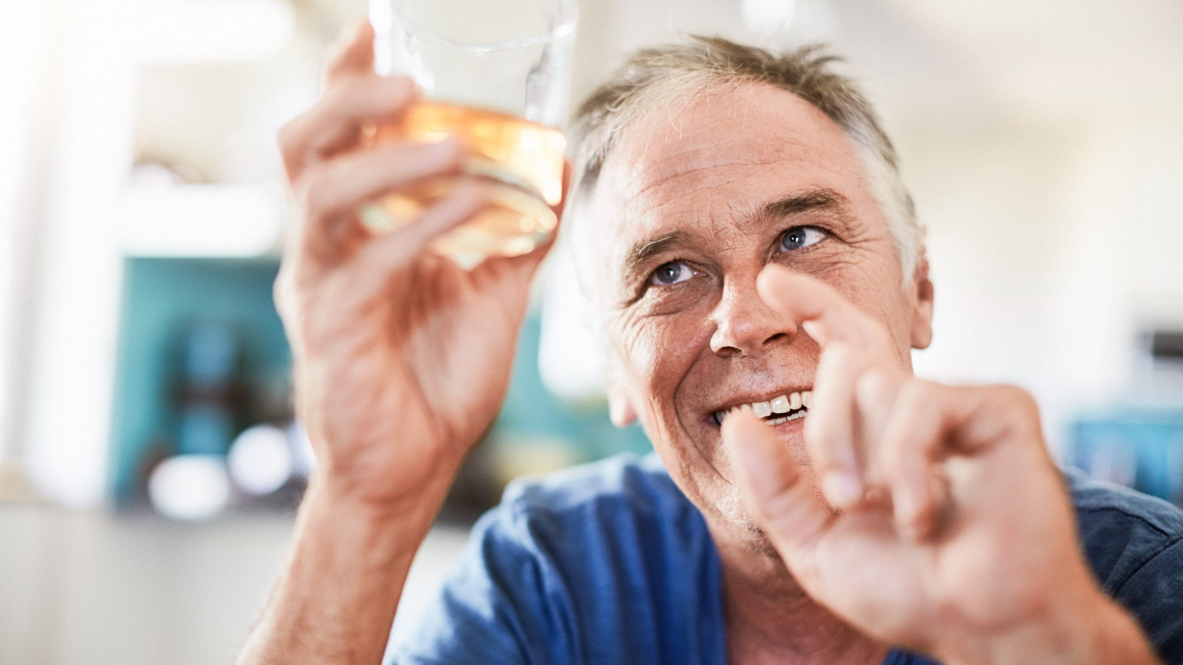 Cheerful man holding a glass of alcohol