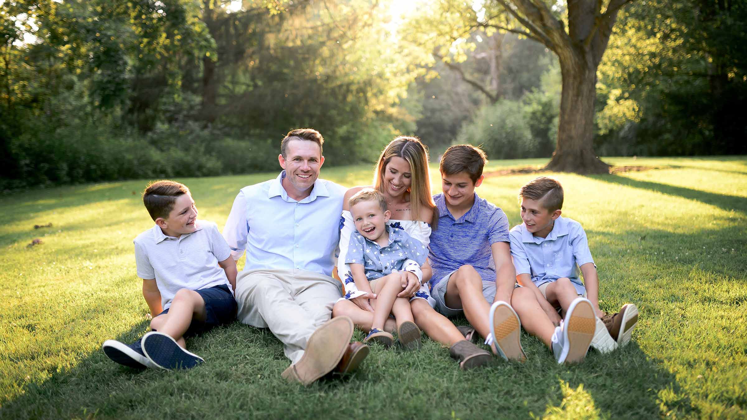 Borah with her husband and kids sitting on the grass