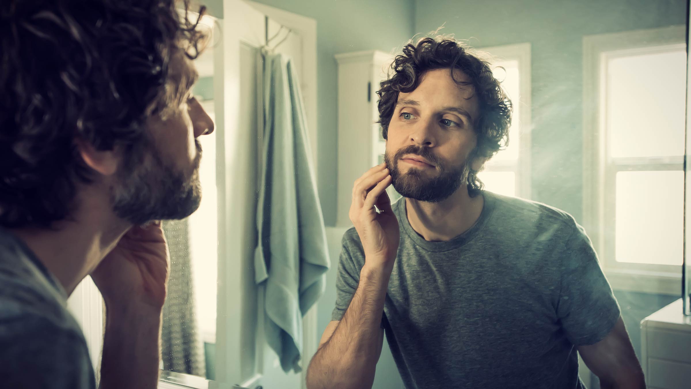 Man checking skin in a mirror