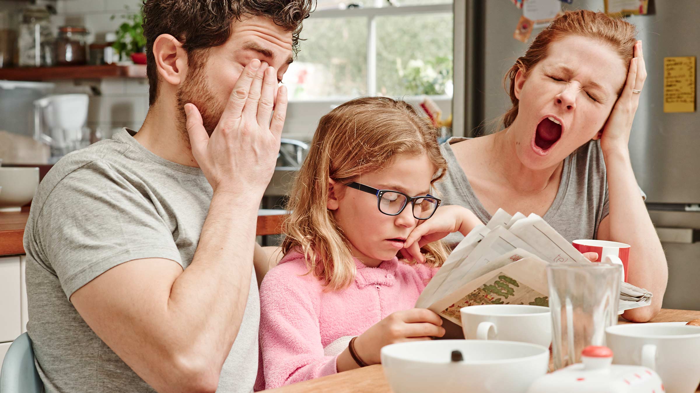 Family at the table, yawning