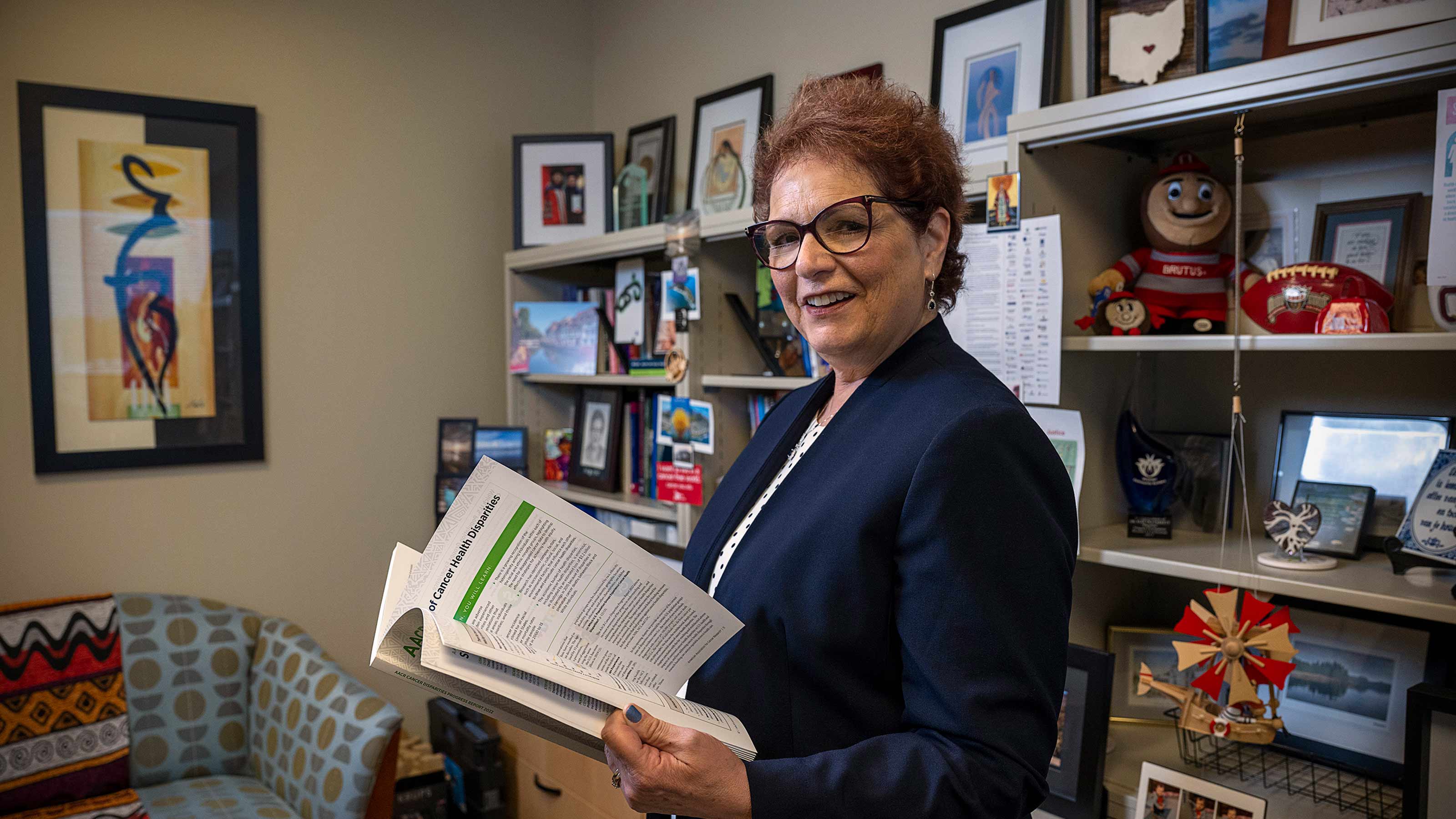 Dr. Paskett holding a book