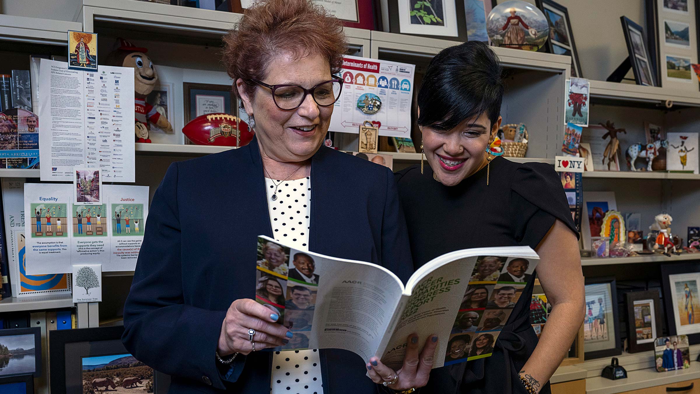 Dr. Paskett and Vianela Ramery reading a book