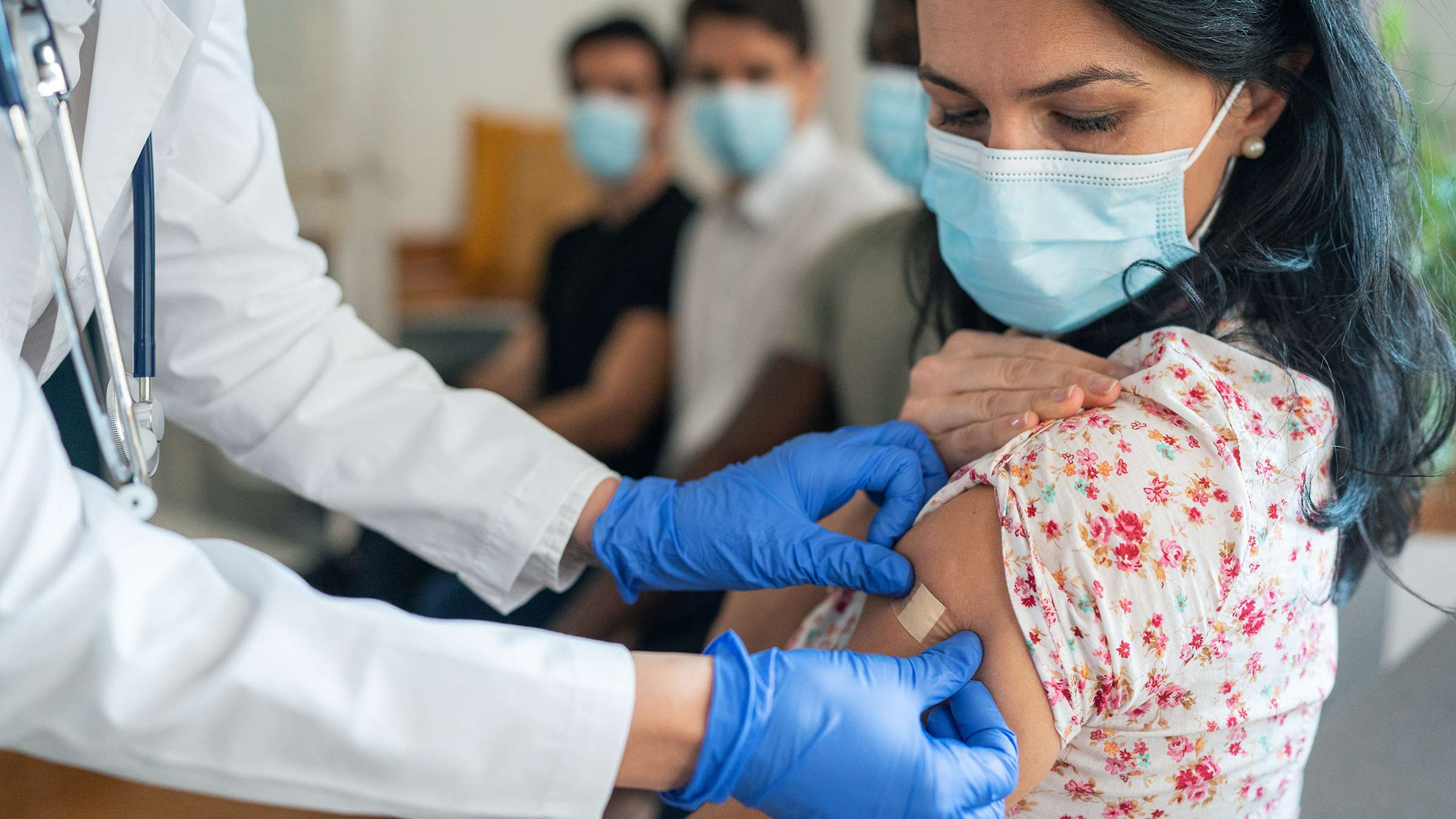 A woman receives her COVID-19 omicron booster shot