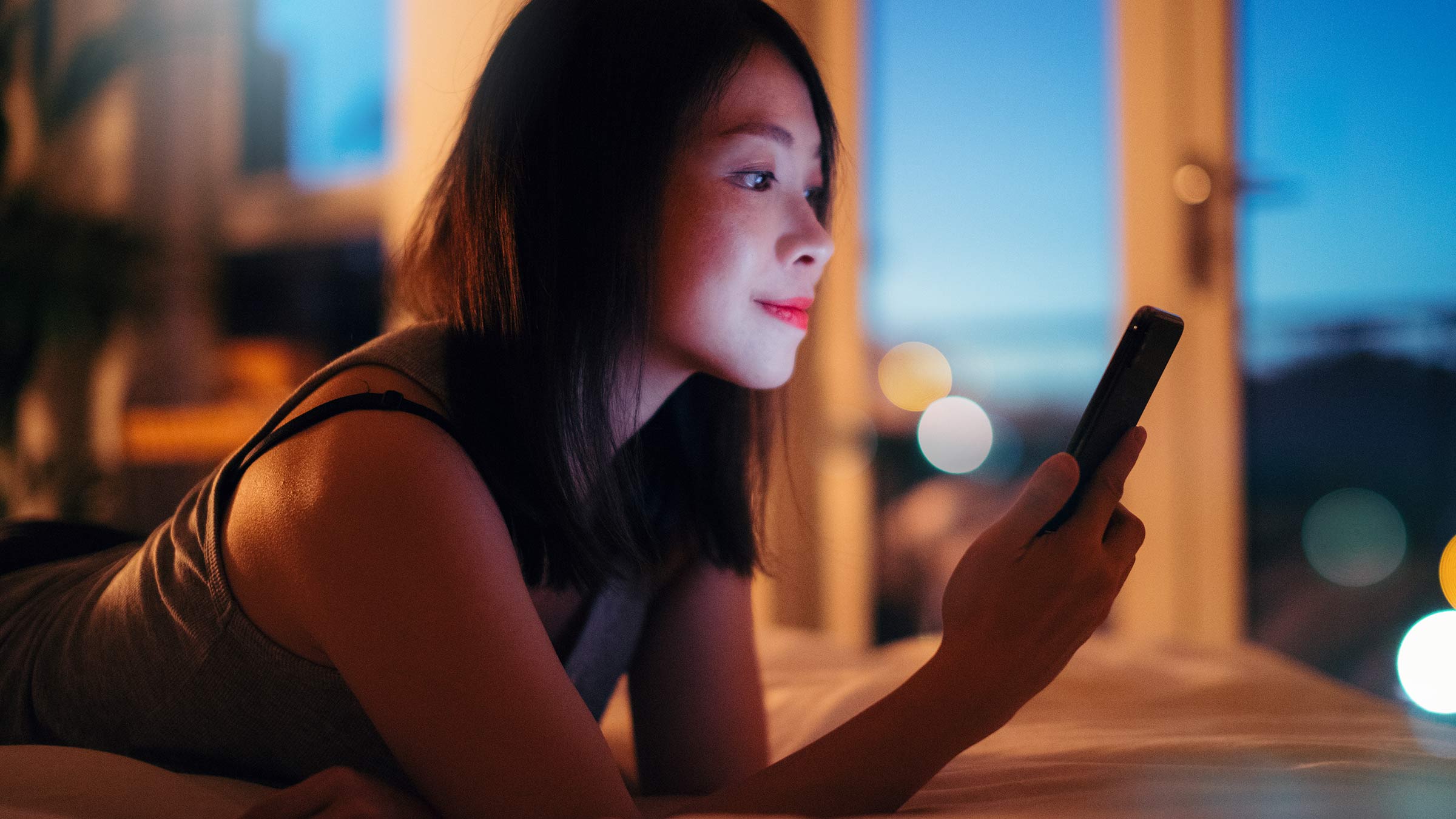 Young woman reading a message on her phone