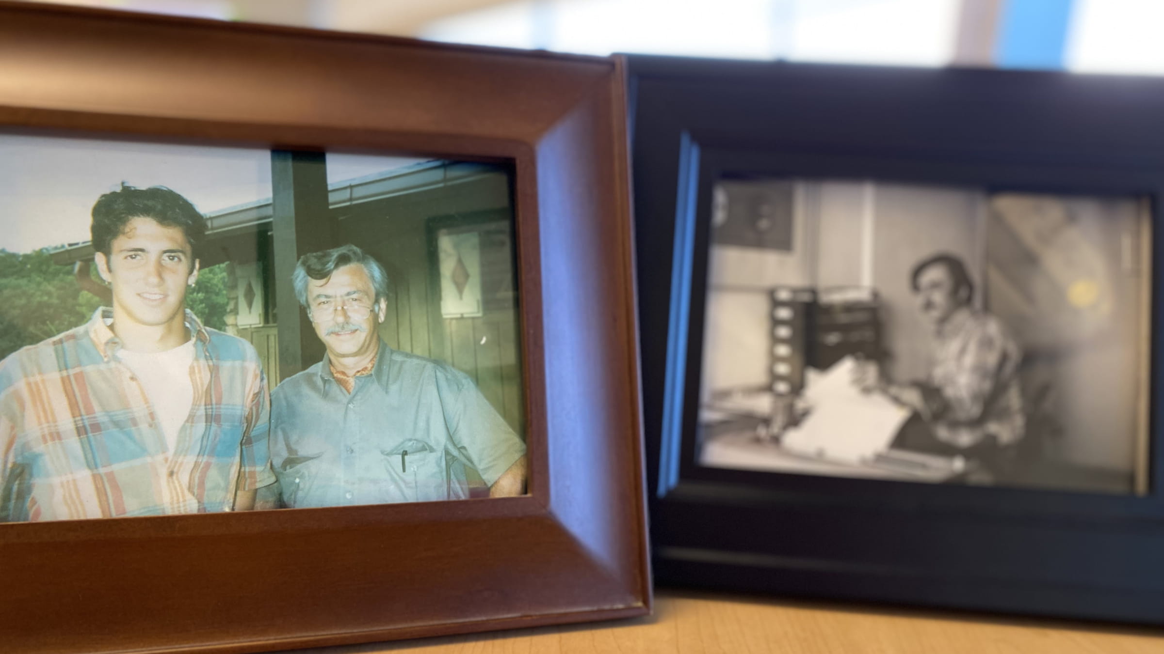 Framed photos, one in color of Steve Kalister with his father and another in black and white  of his father