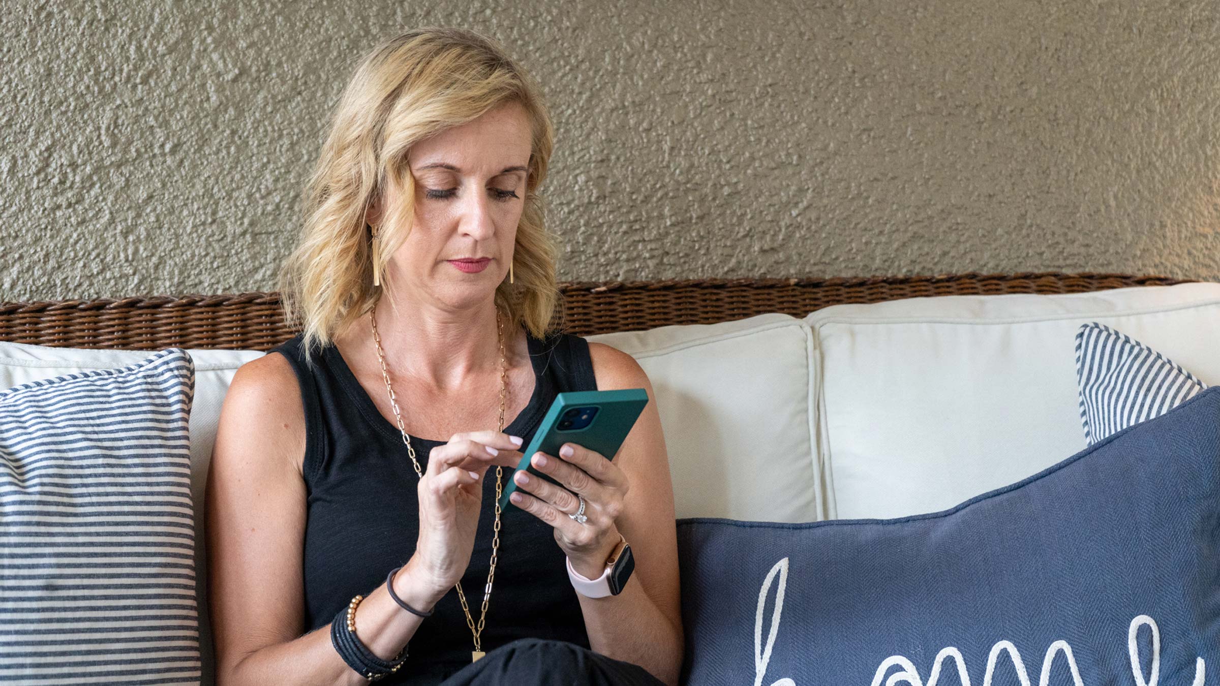 A woman scrolls on her phone before falling asleep