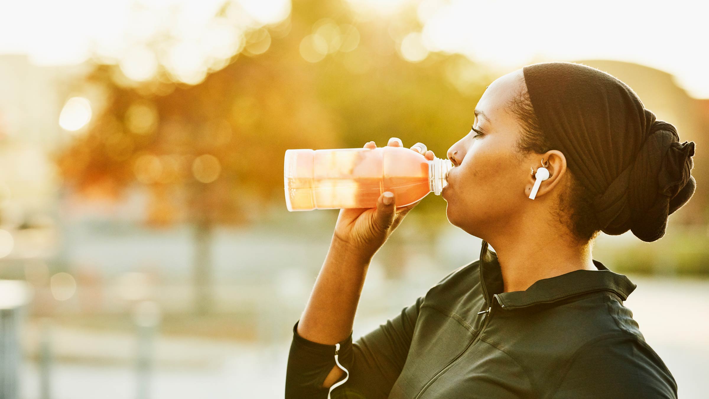 Woman drinking a sports drink after a workout