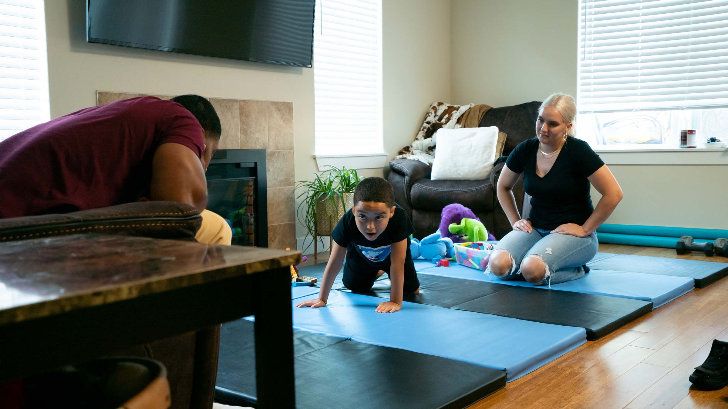 Jamell and Shante Stagg help their son, JuJu, through a regimen of daily physical therapy exercises