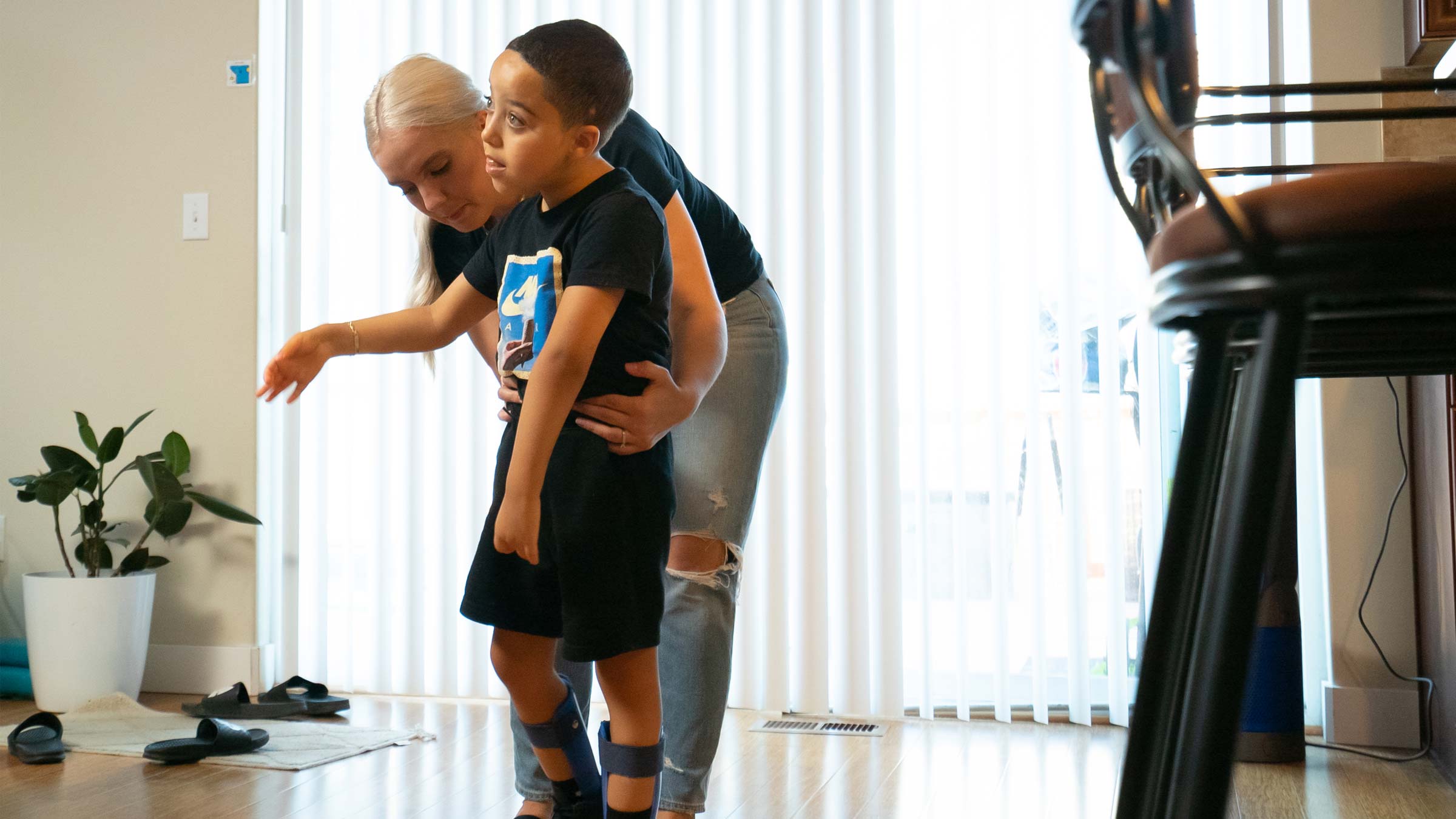 JuJu's mother, Shante Stagg, helps him as he learns to walk