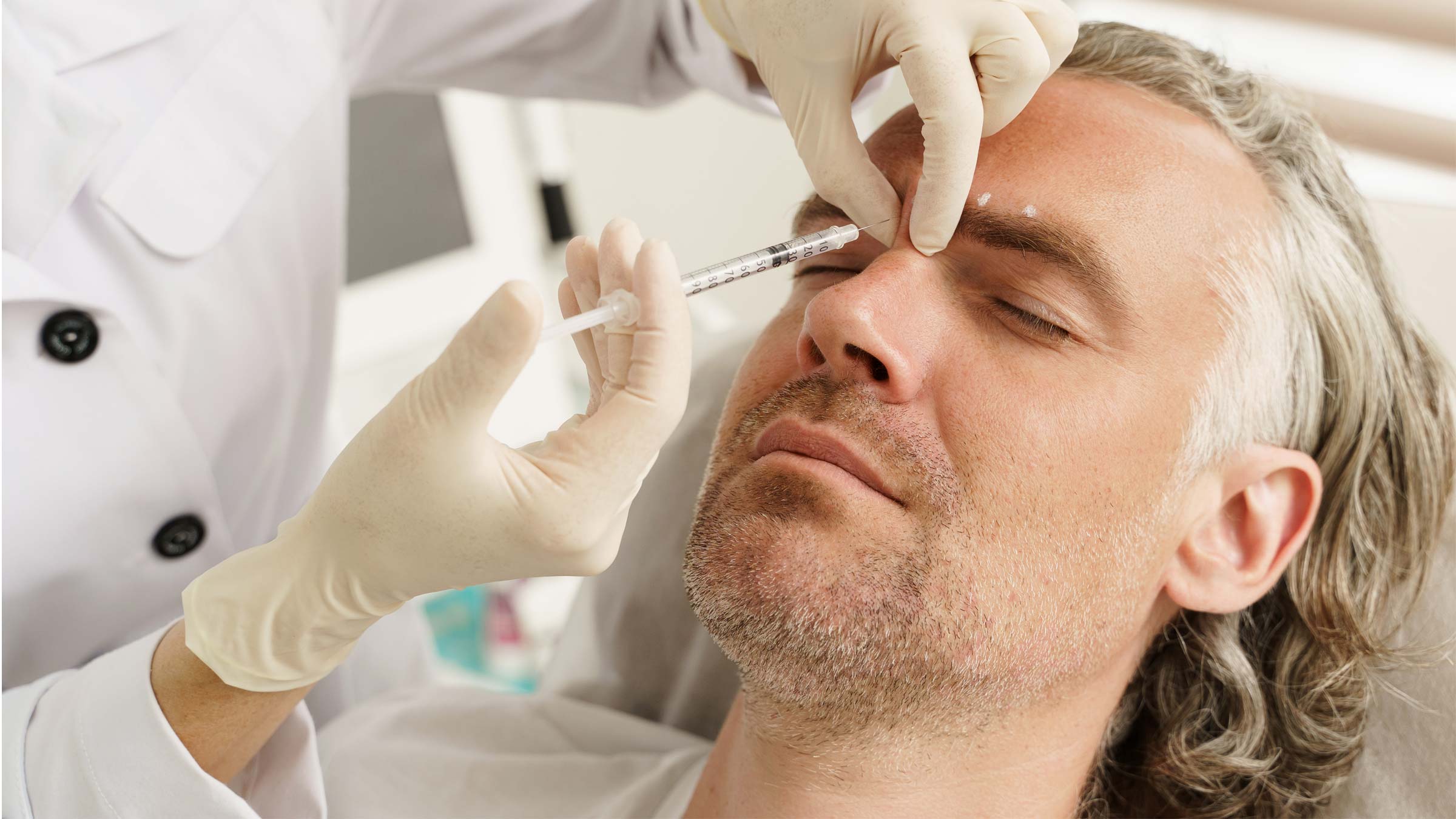 Male patient receiving filler (Botox) injections 