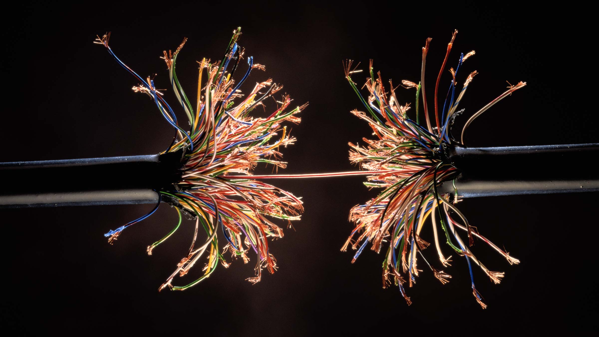 A frayed wire being pulled apart.