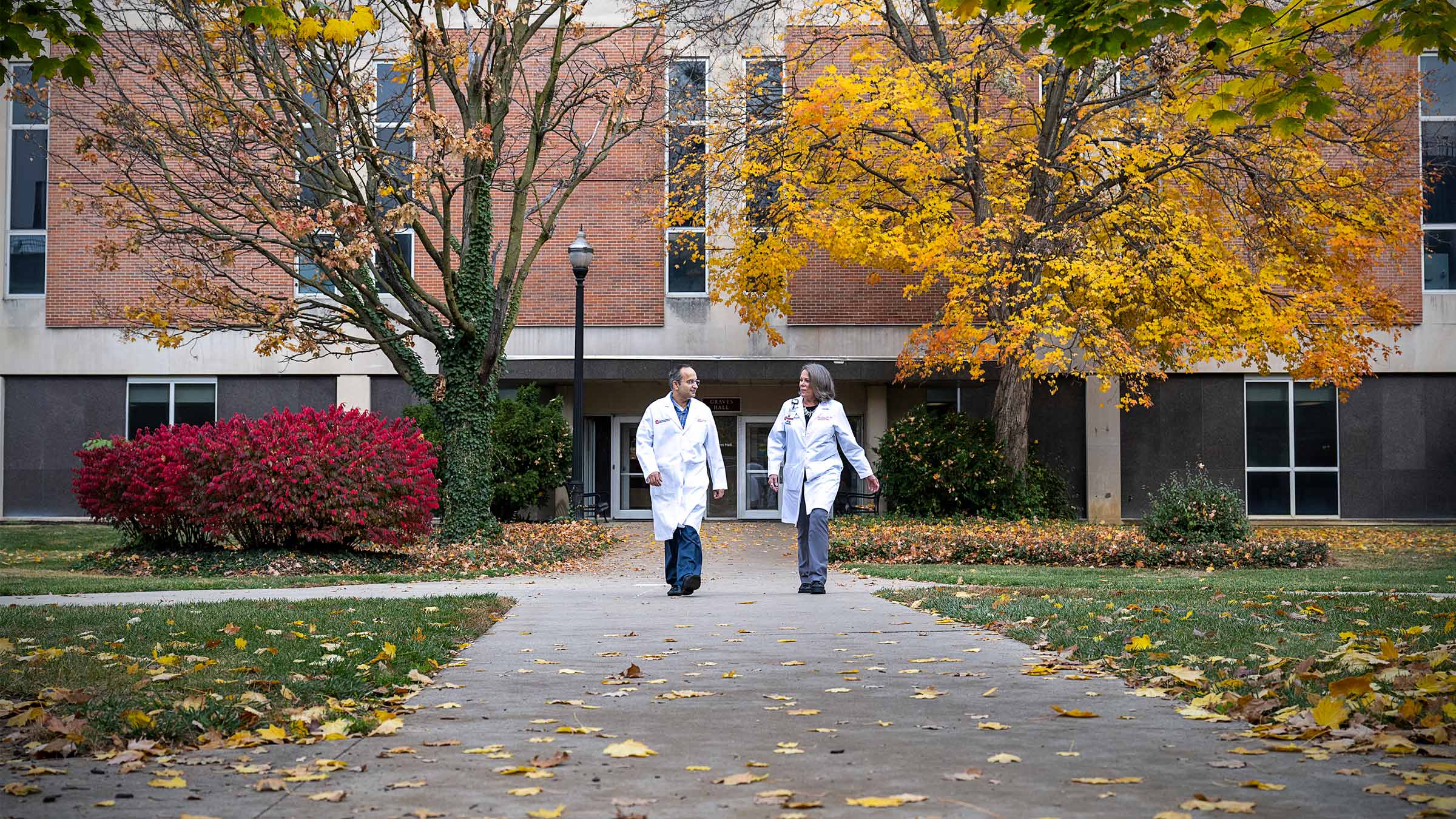 Deepak Gulati, MD, talking with another provider on Ohio State campus