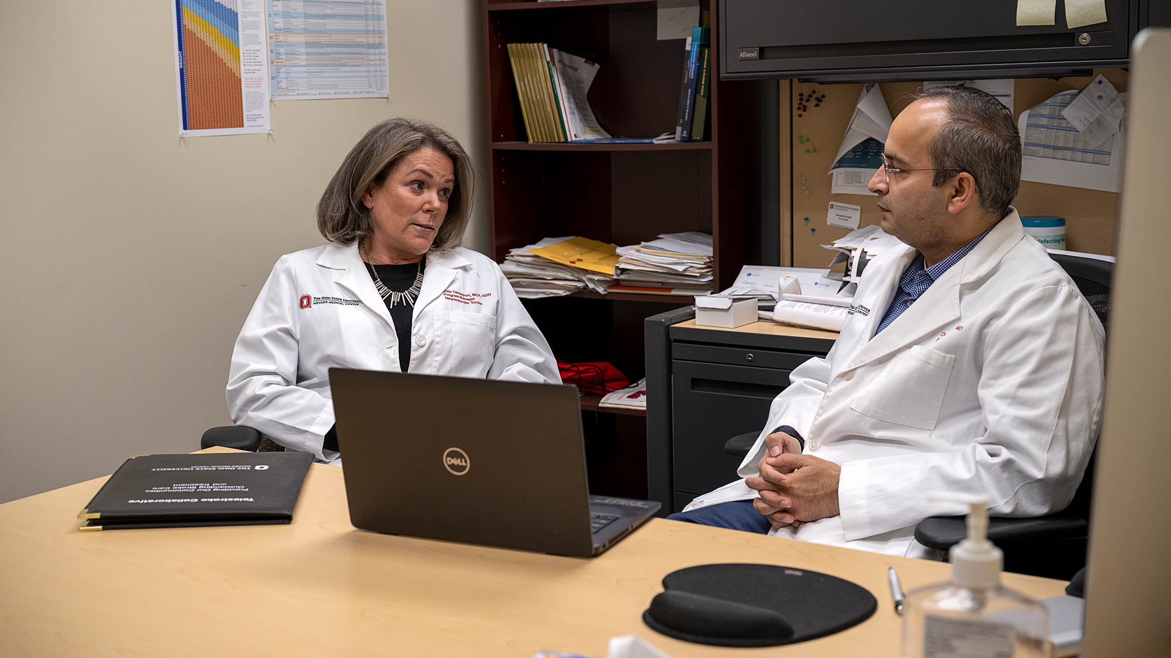 Deepak Gulati, MD, talking with another provider at Ohio State