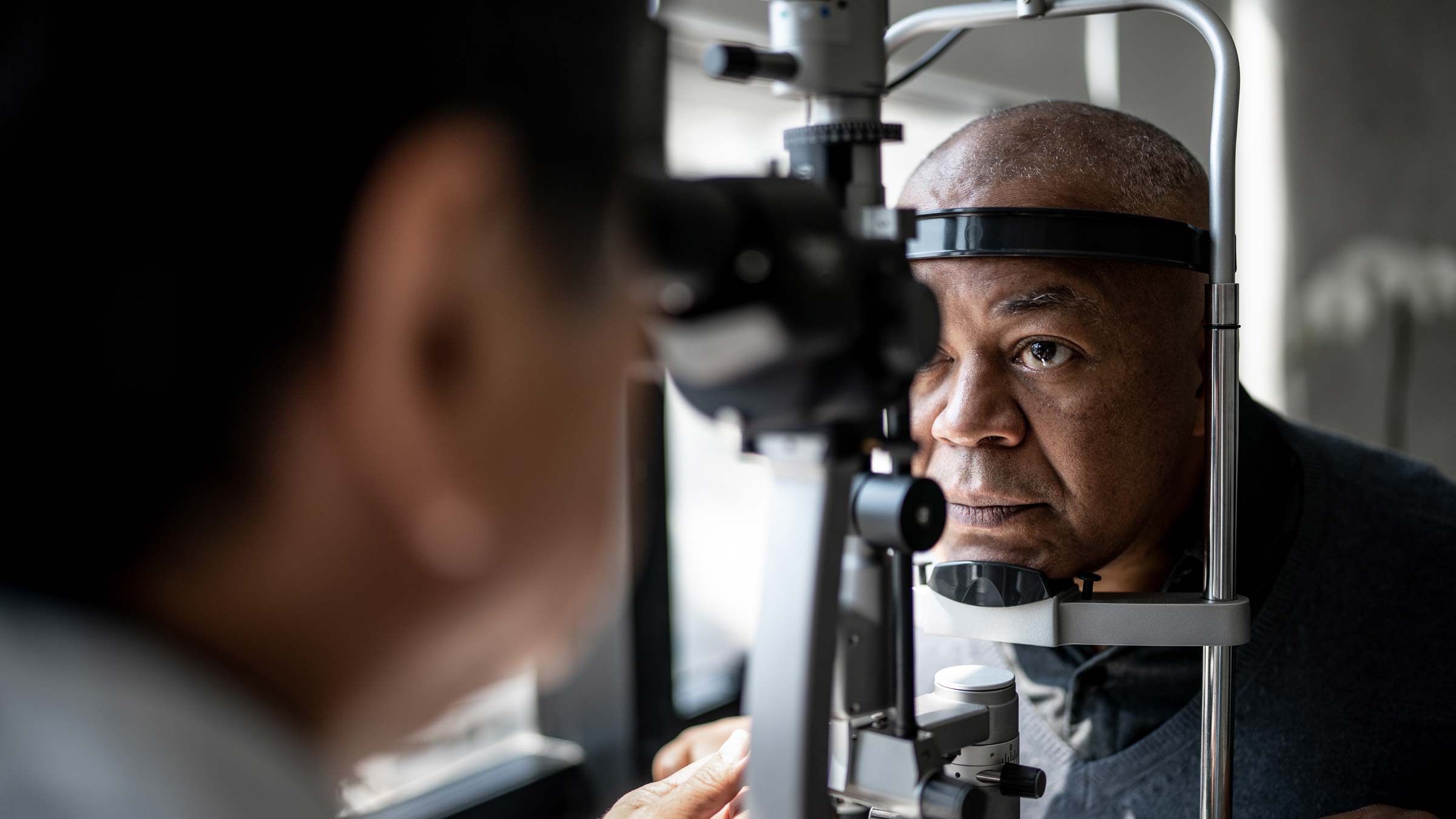 Ophthalmologist examining patient's eyes