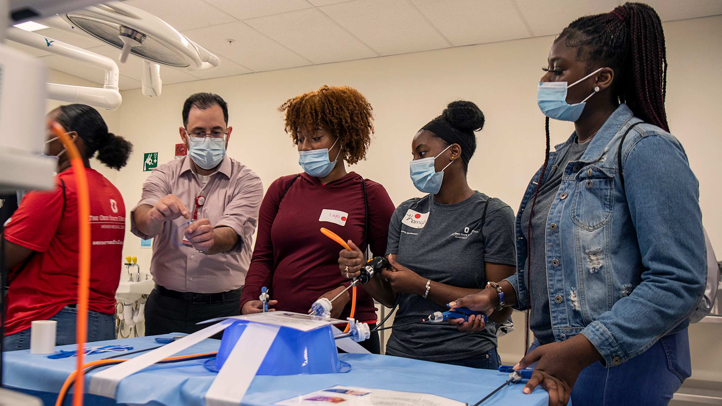 Frank Piscitani, associate director of Ohio State's Surgical Skills Lab, leads a simulation on laparoscopic surgery to a group of high school students