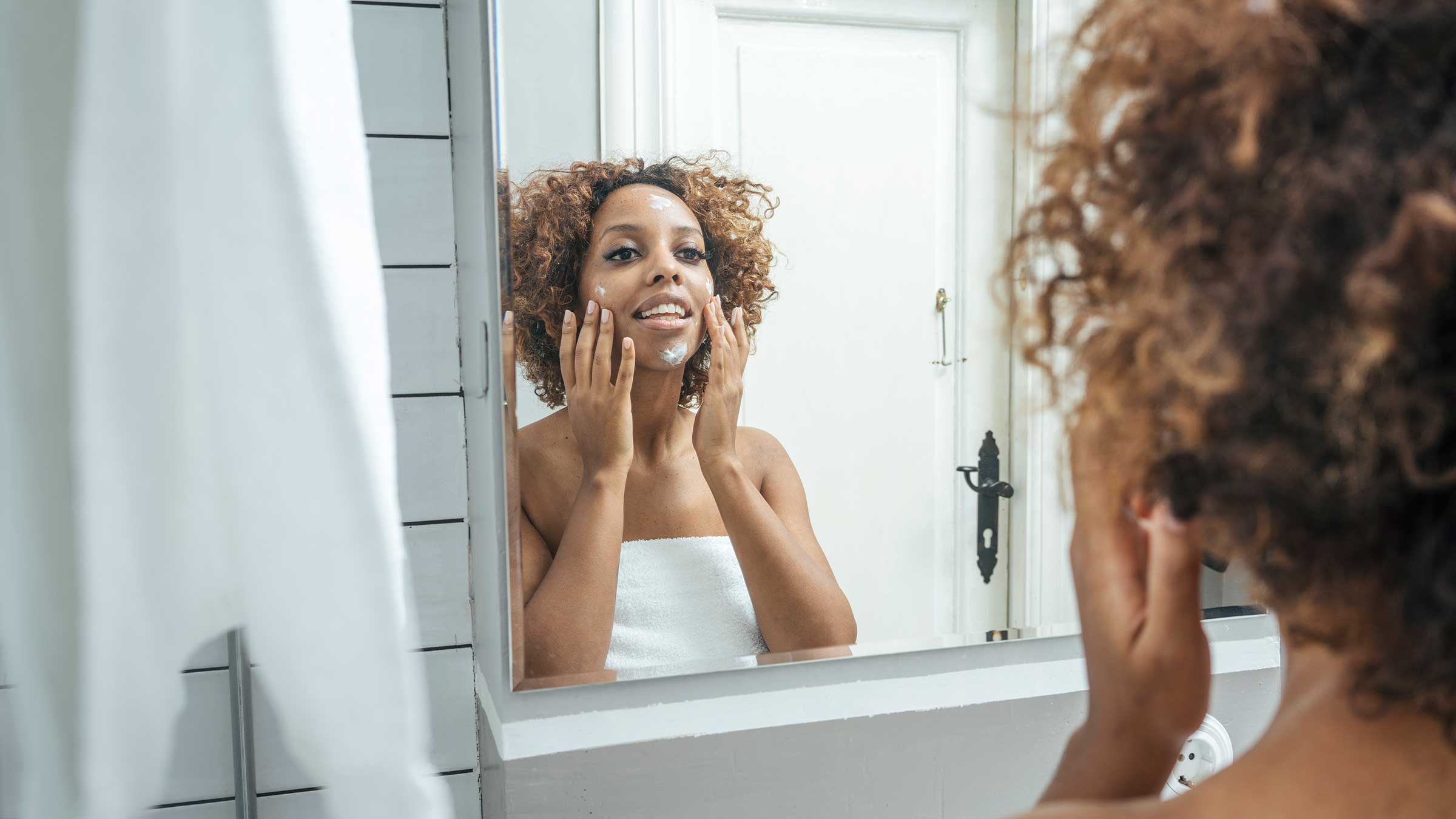 woman cleansing her face