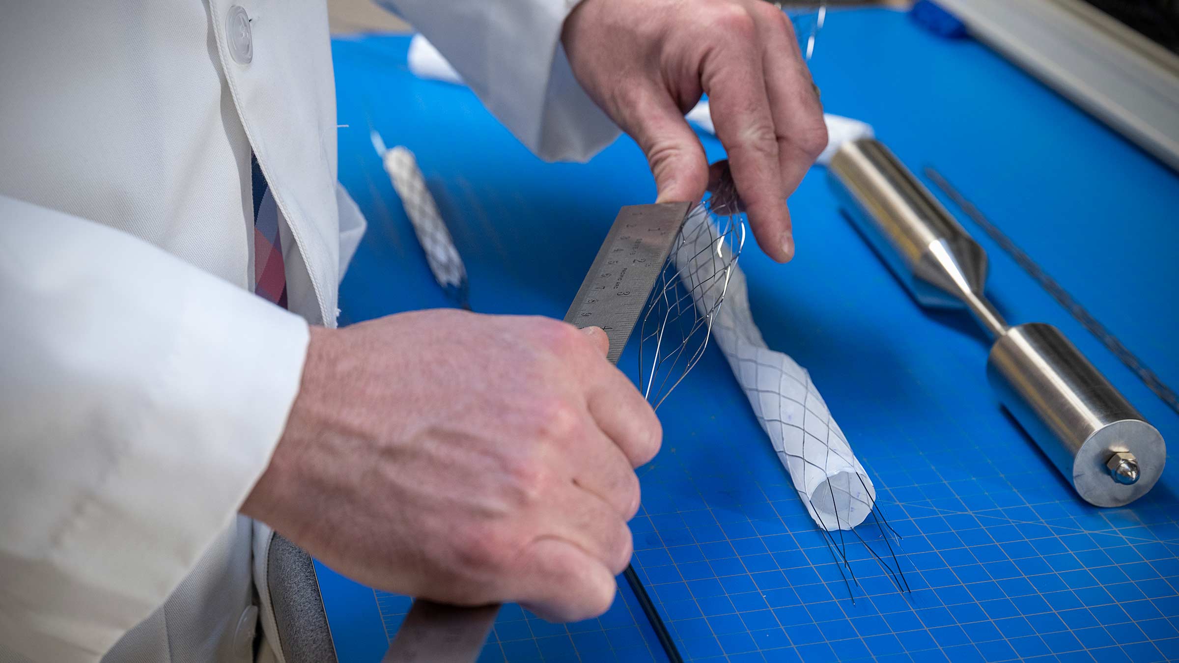 Bryan Tillman, MD, PhD, works on the retrievable rescue stent in his lab.