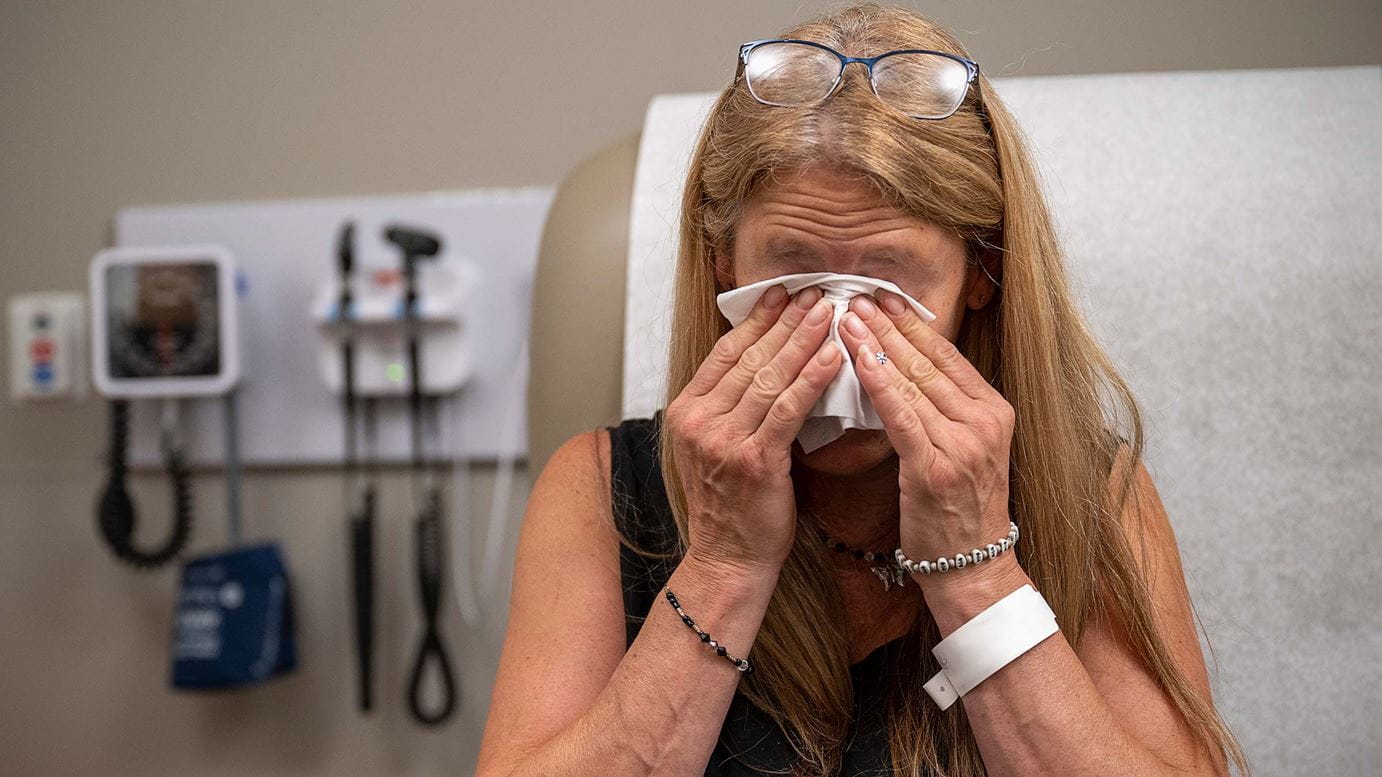 Diana Robertson wiping tears from her eyes