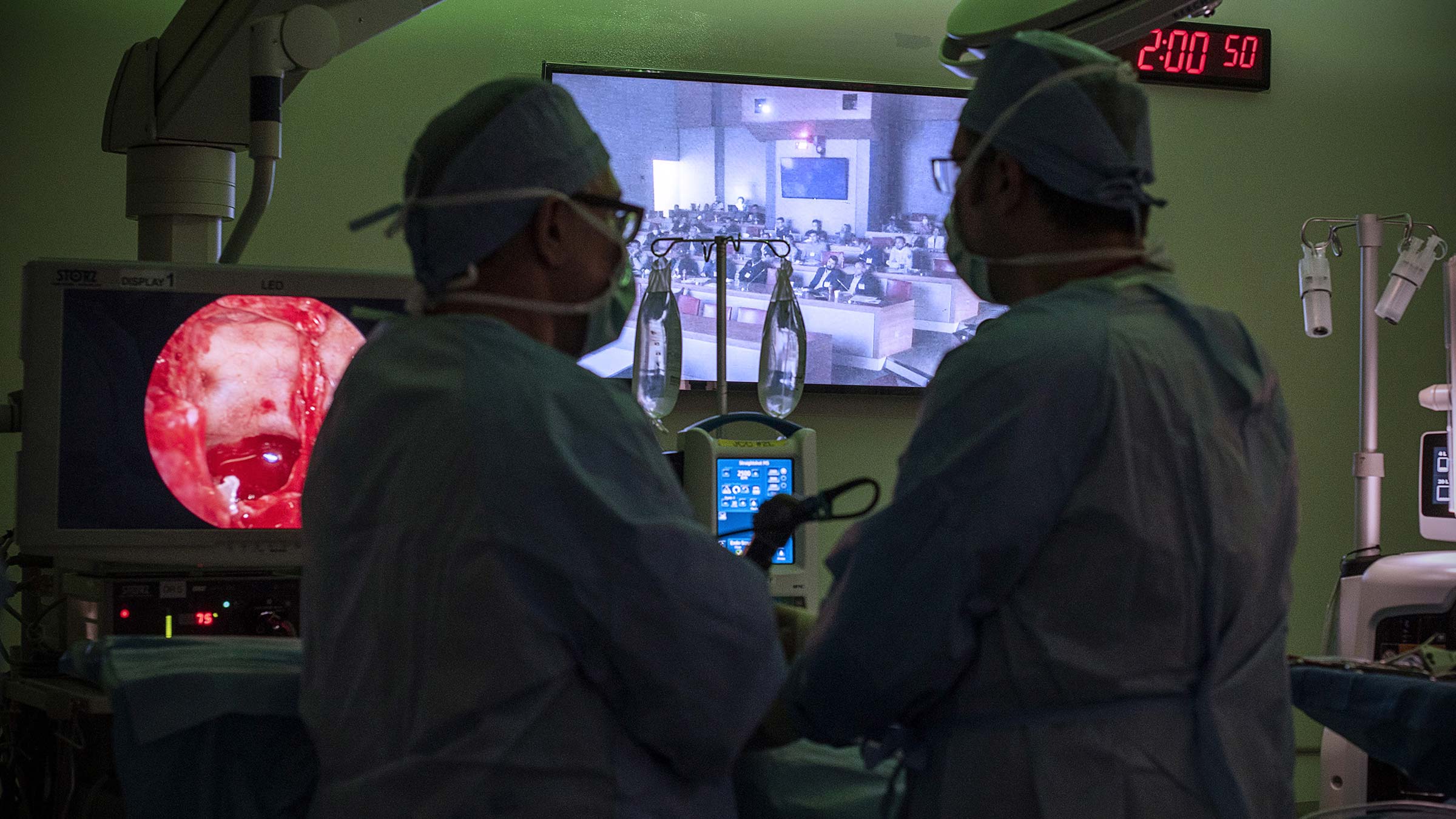 Two surgeons performing endoscopic endonasal surgery to remove a skull base tumor
