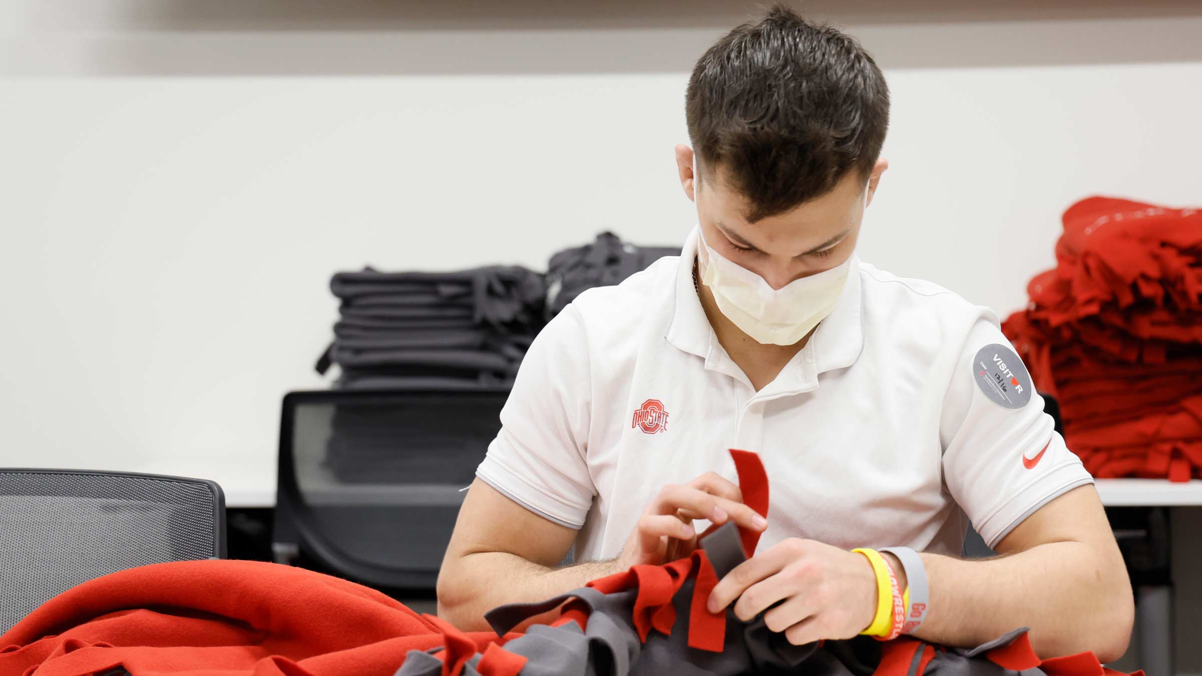 Nic Bouzakis making a blanket for chemotherapy patients