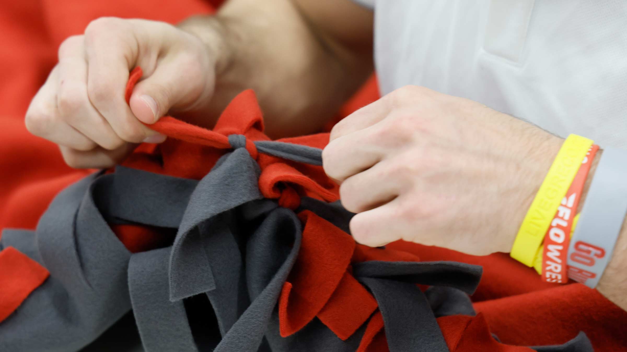 Close up of a member of the Ohio State wrestling team making a blanket