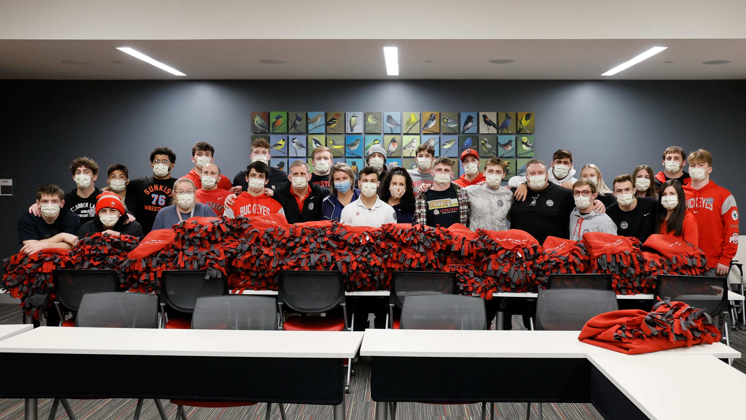 Members of The Ohio State University wrestling team show off the nearly 80 blankets that they made.