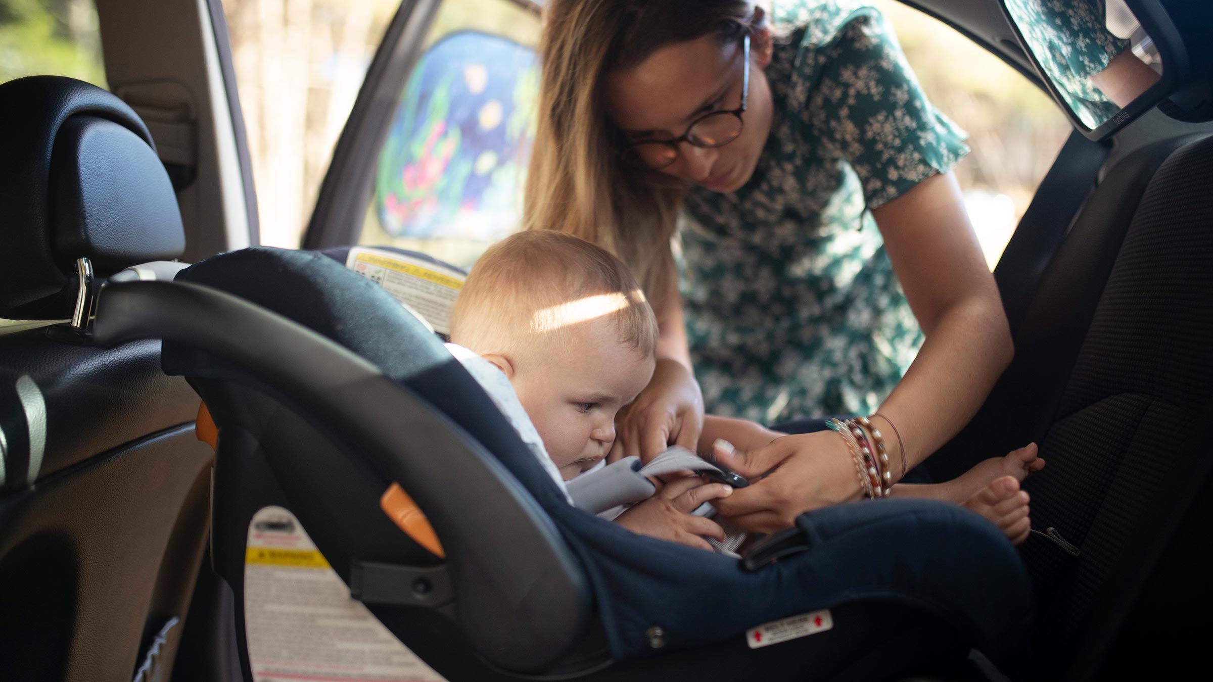 Woman with toddler in a car seat