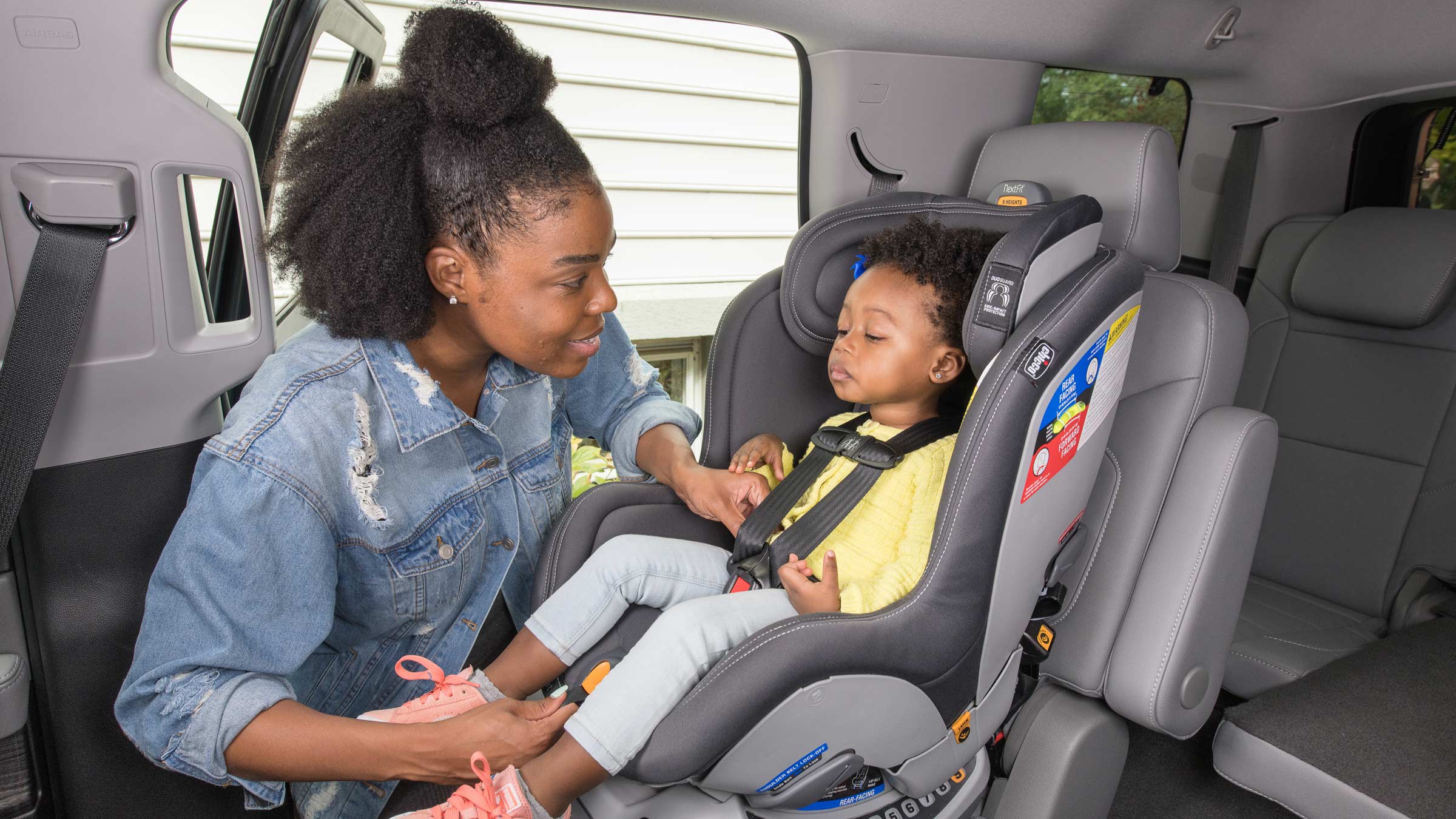 Woman with toddler in a car seat