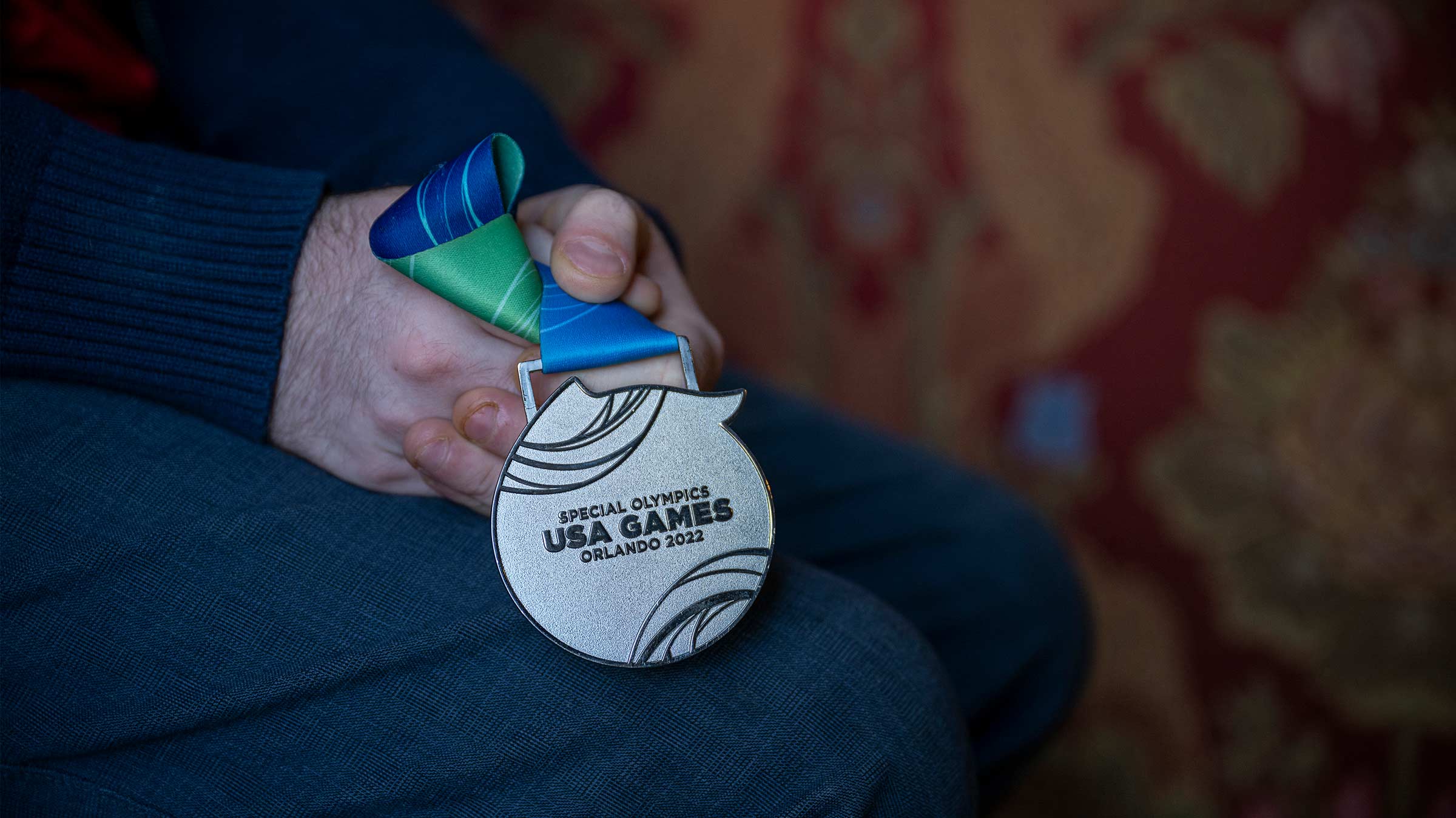 James Shannon holds his silver medal from the 2022 USA Special Olympics