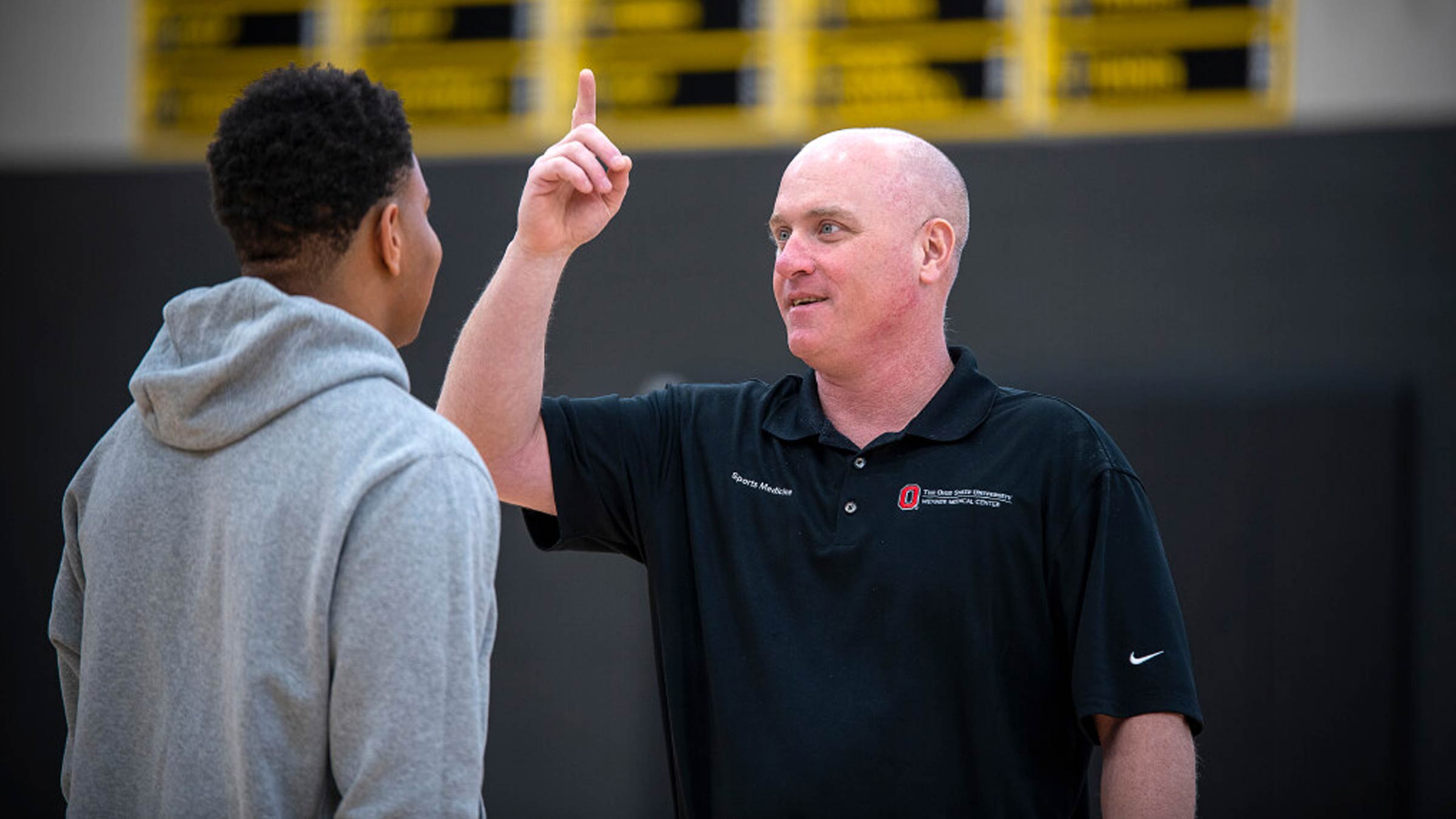 Tom Evans, AT, chats with a student-athlete at Upper Arlington High School.