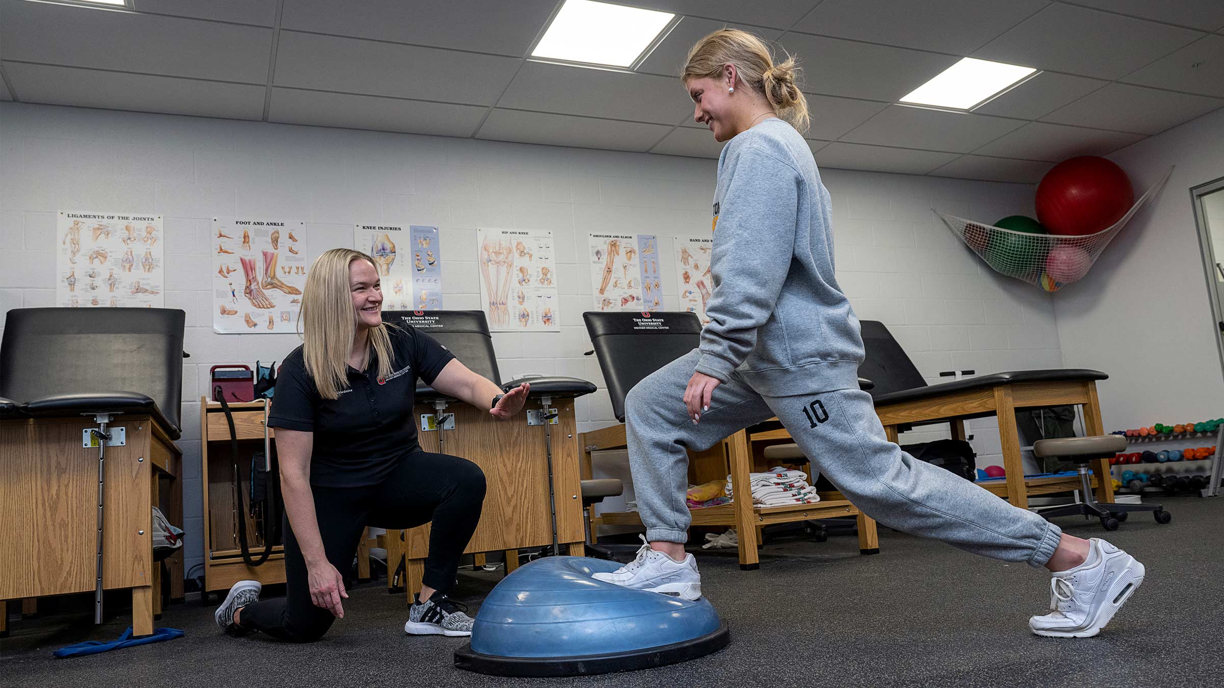 Katelyn Dilley, MS, AT, an athletic trainer at The Ohio State University Wexner Medical Center, helps a student athlete at Upper Arlington High School