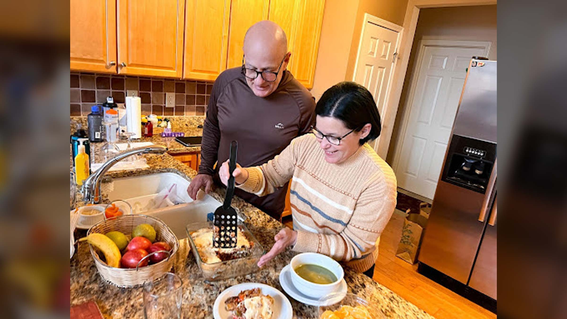 Angel Kowalski, a cancer survivor, prepares meals for the week with his wife.