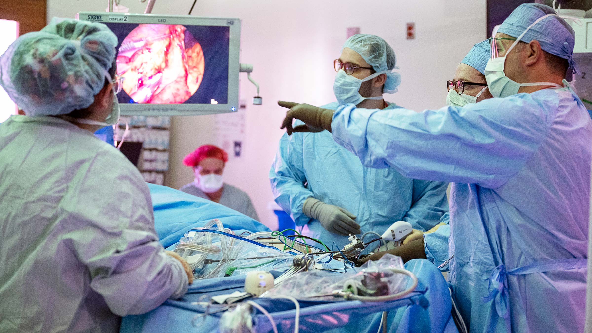 Dr. Kalady pointing at a screen in the operating room