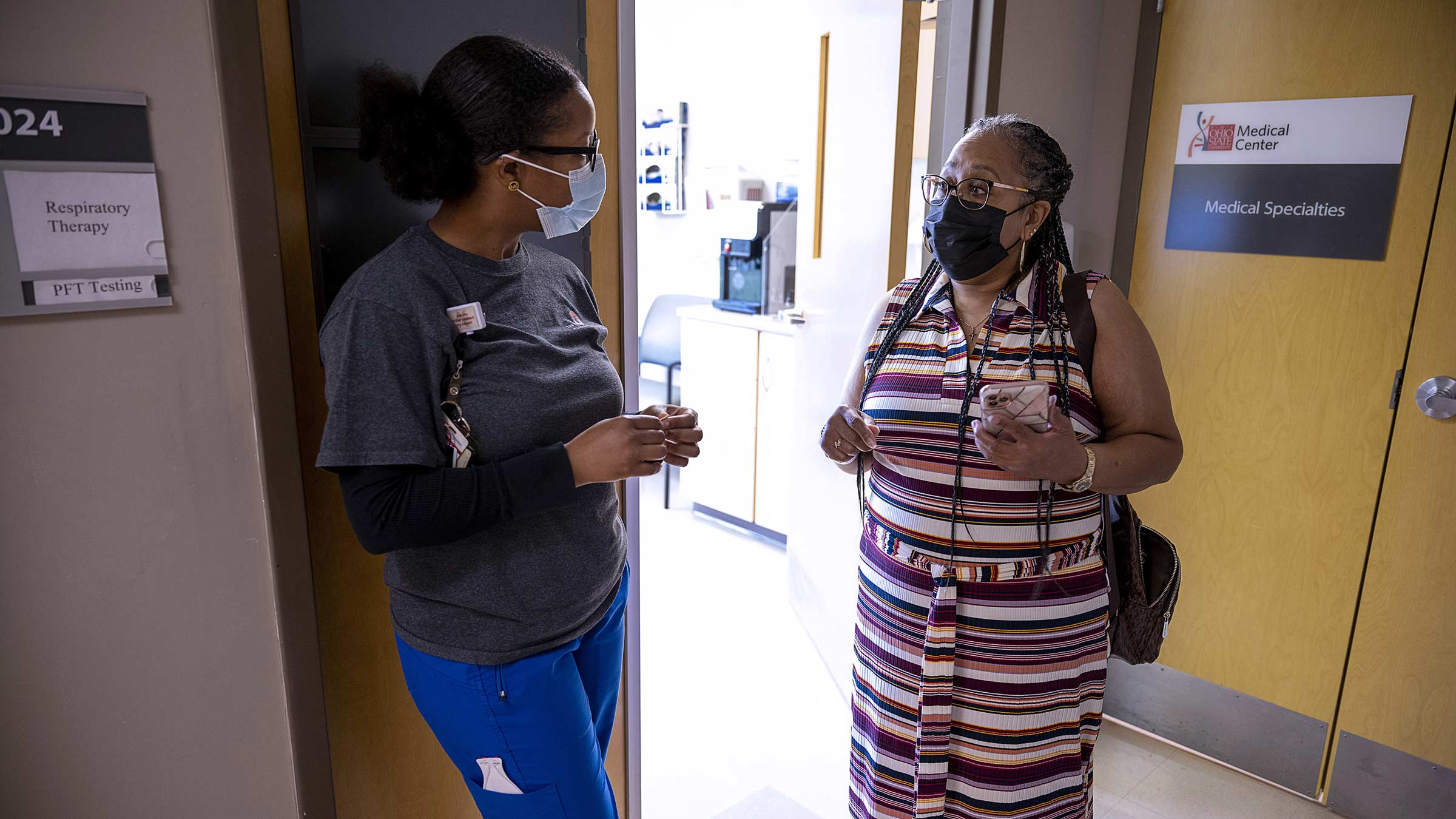 April Muldrow talks with medical staff member outside of respiratory therapy