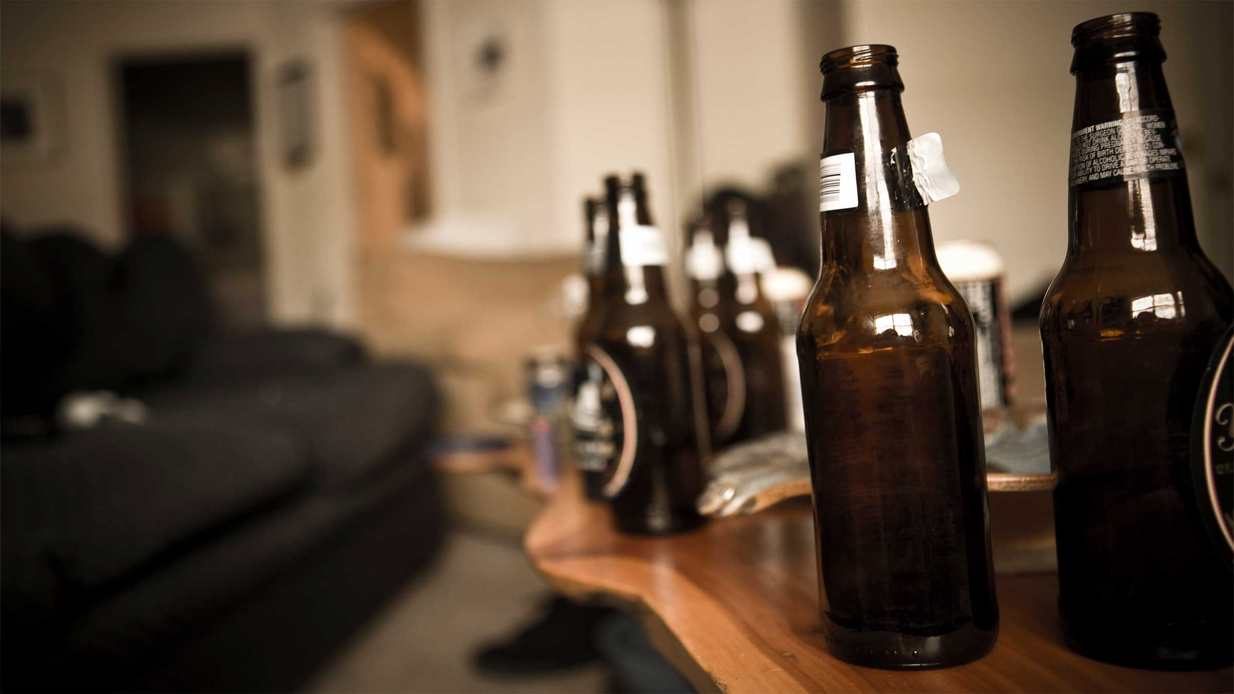 Empty beer bottles on table.
