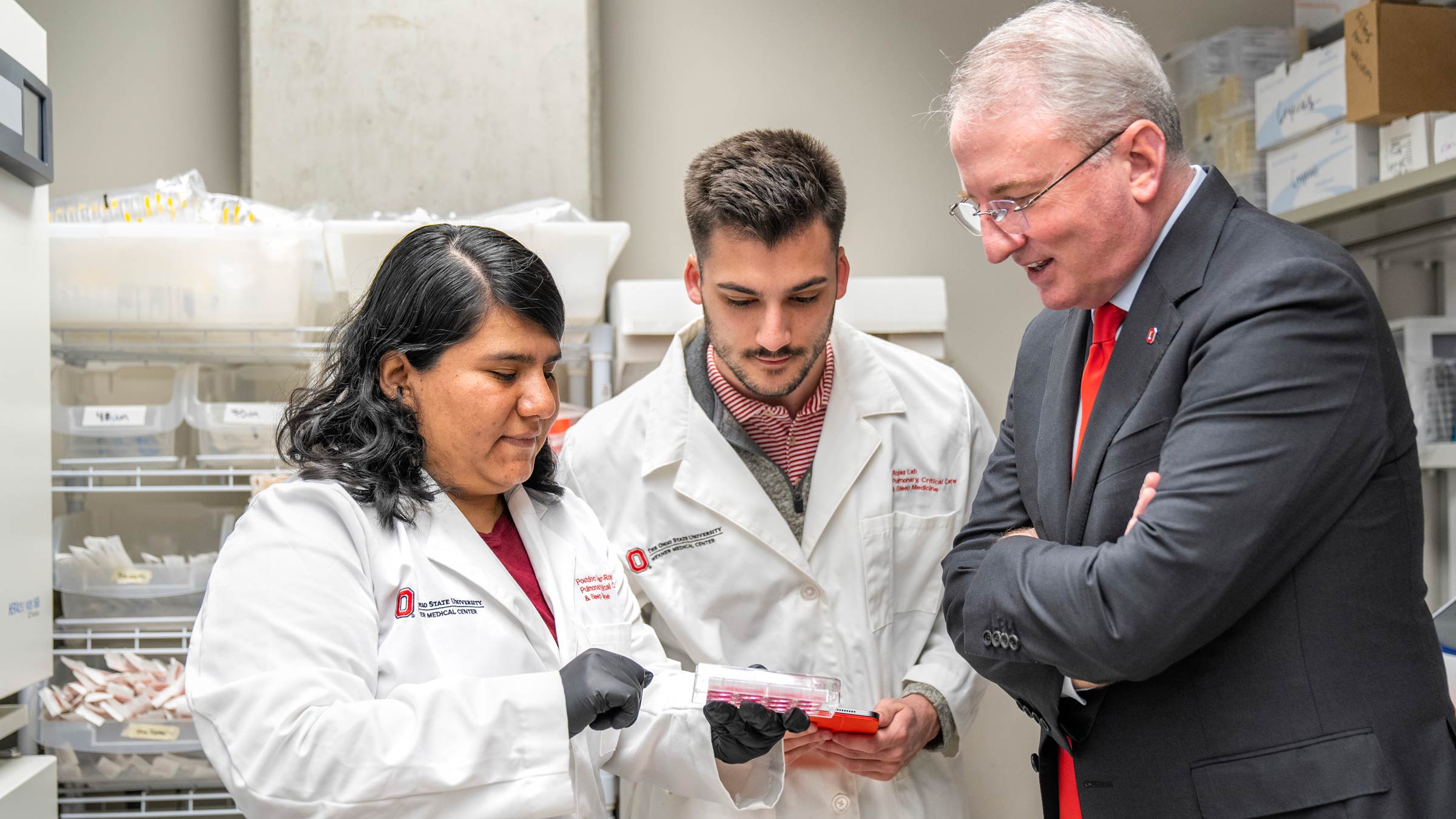 John J. Warner, MD, talking to Ohio State researchers in lab