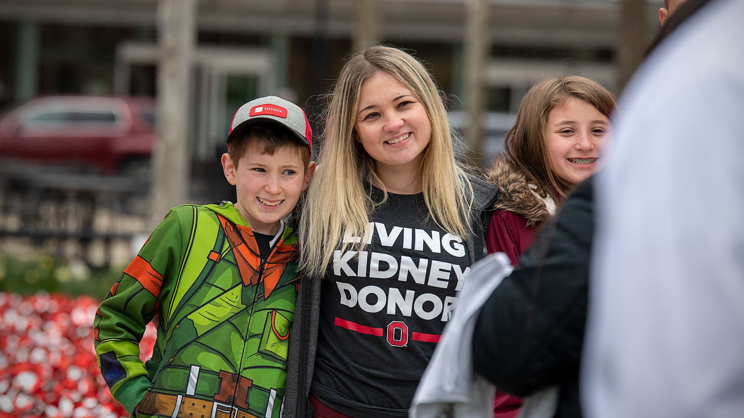 Family posing together wearing living kidney donor t-shirts