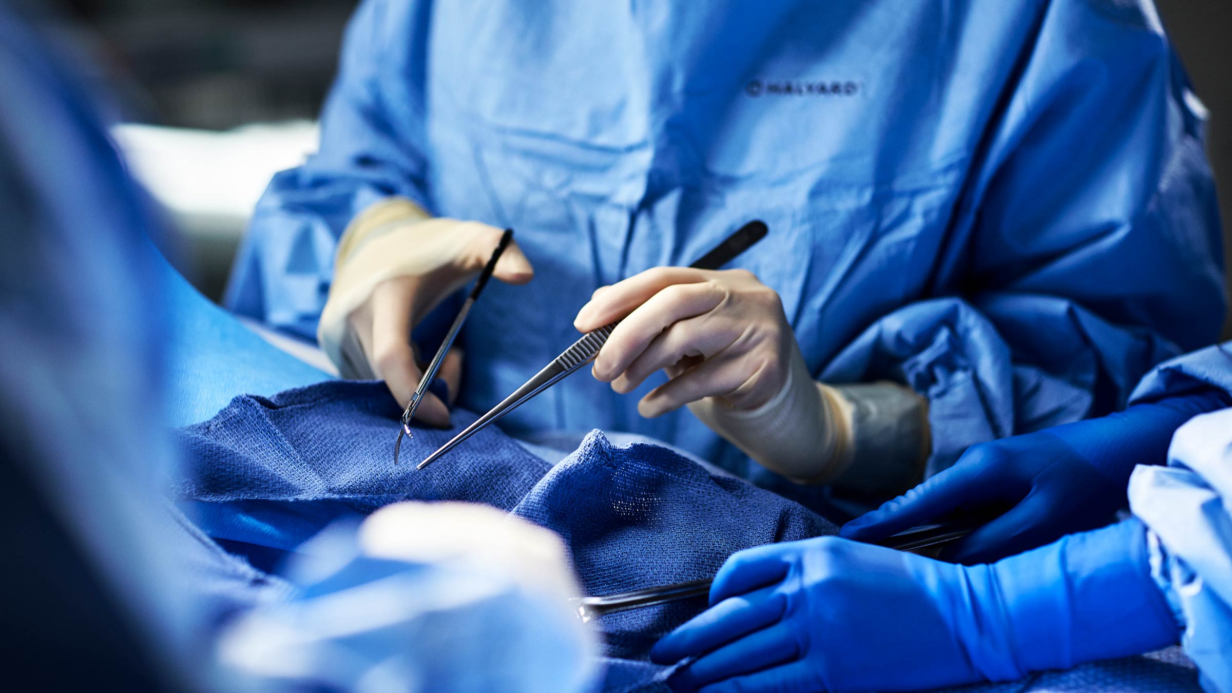 Cardiac surgeons holding surgical instruments