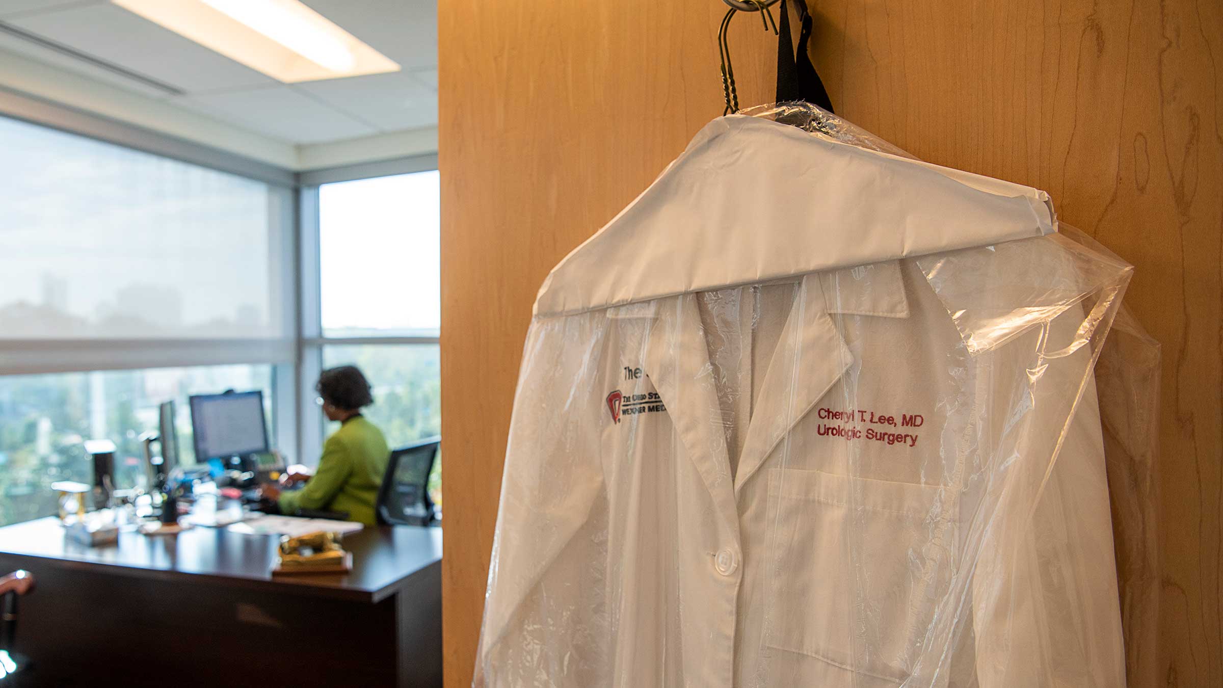 Dr. Cheryl Lee’s white doctor’s coat hung on a door in her office