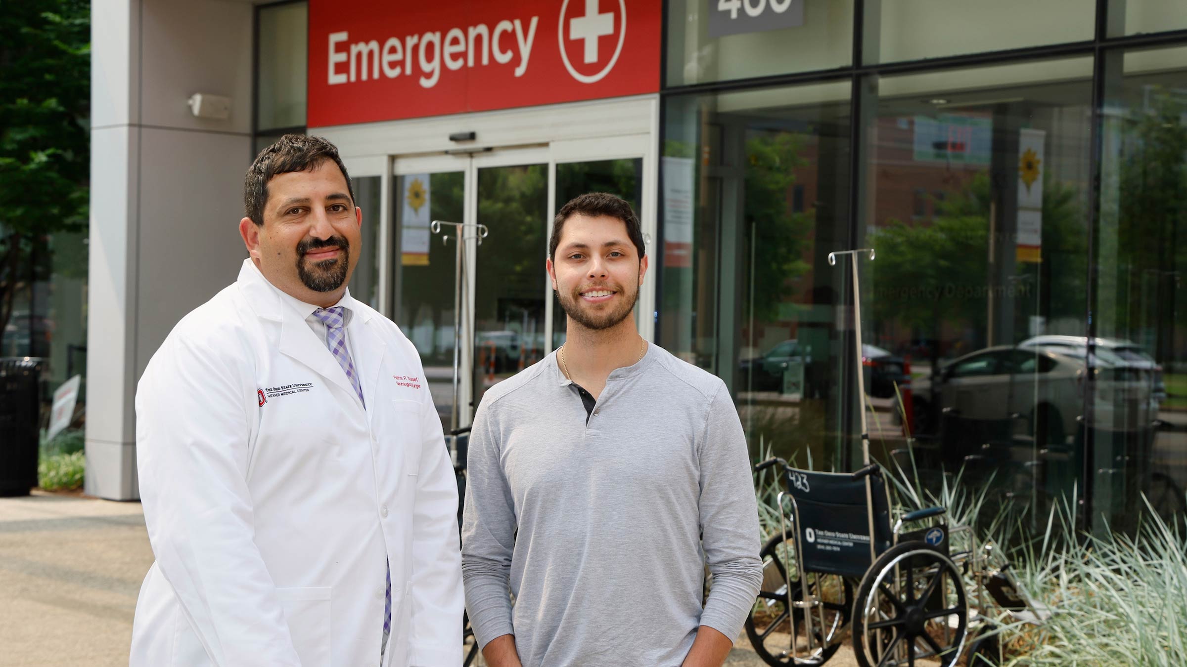 Stephen Vidman, stroke patient, and his doctor, Patrick Youssef, MD, a vascular neurosurgeon in front of the emergency room entrance