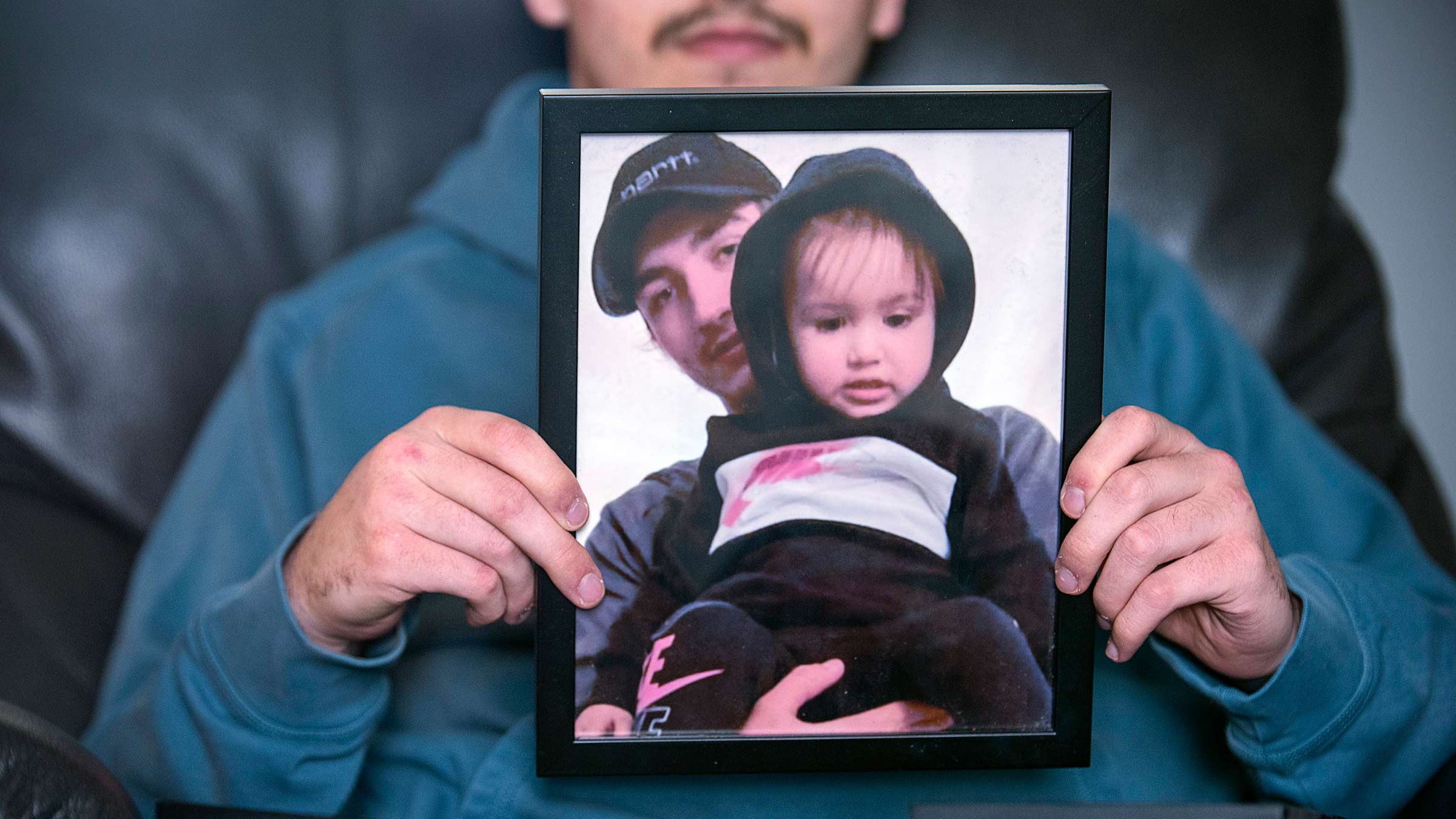Cameron holding the photo of his daughter