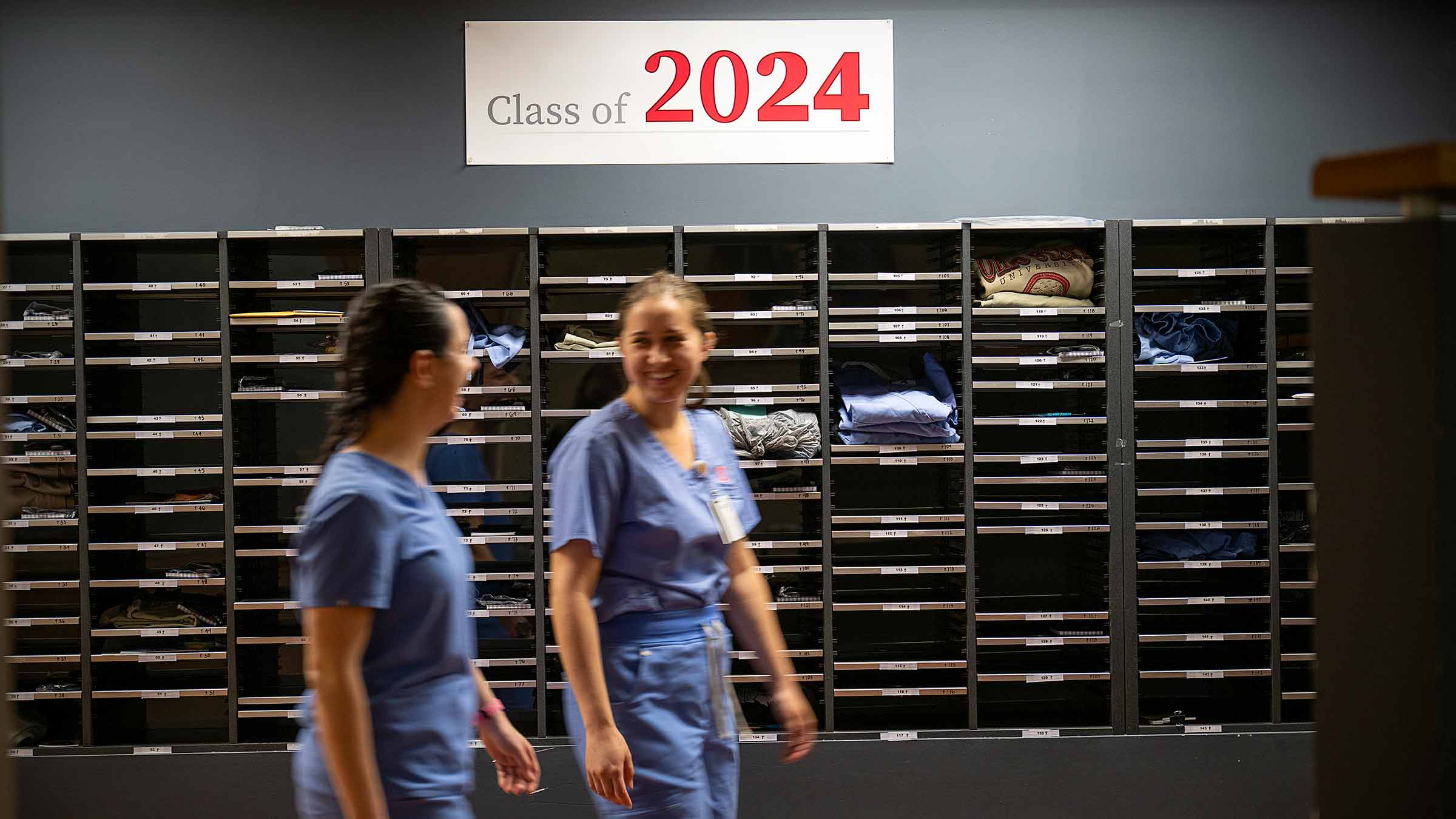 Students walking past "Class of 2024" sign