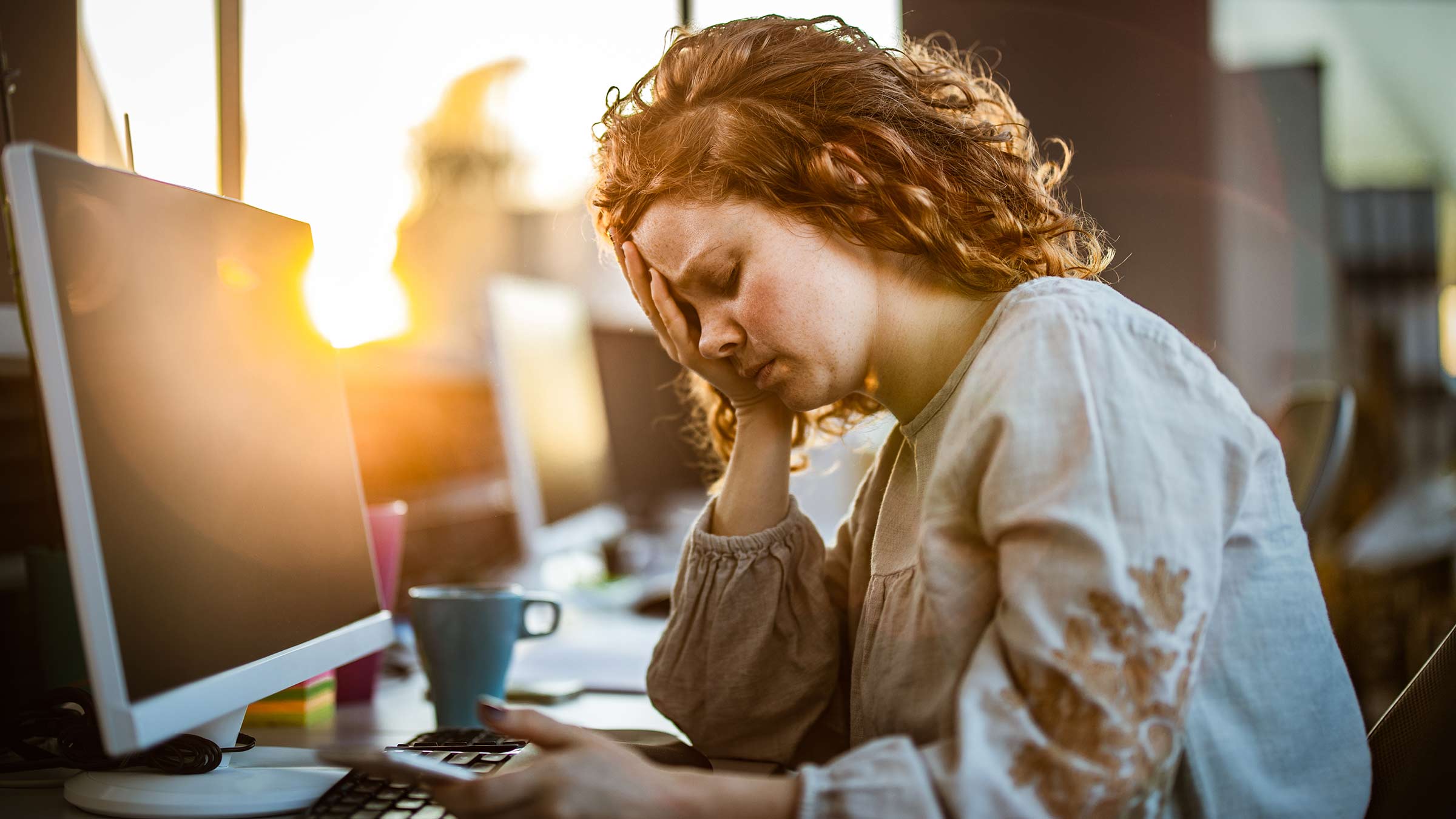 A woman with anemia experiences fatigue at work