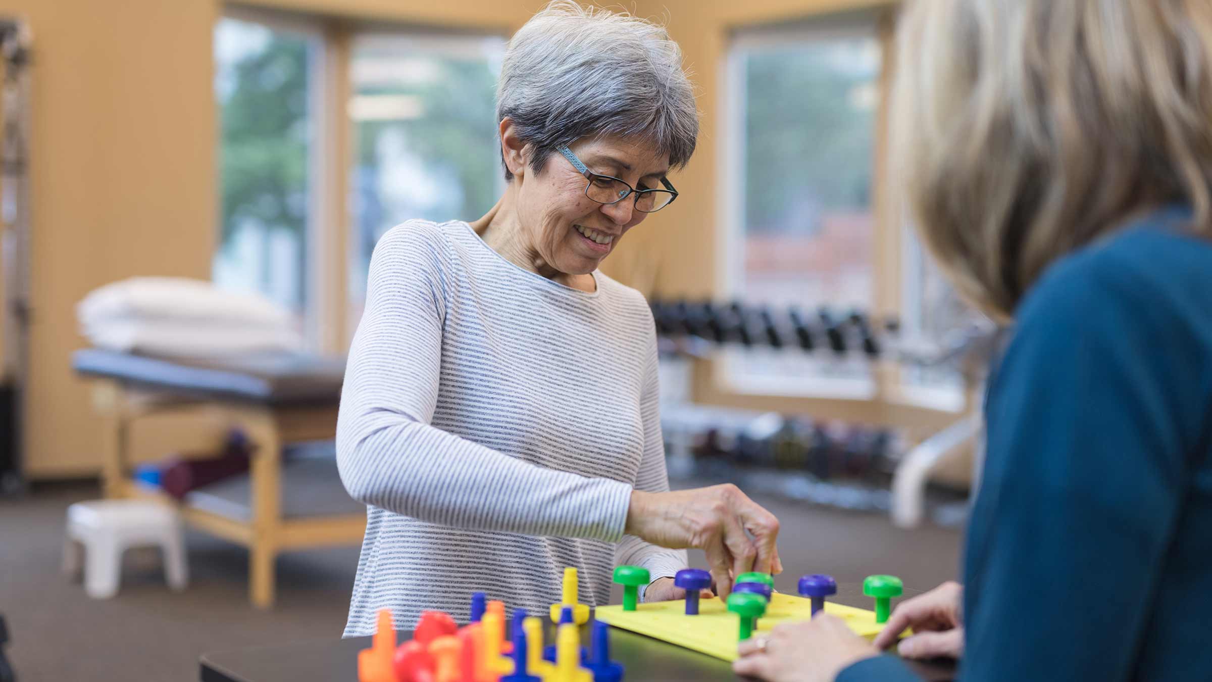 Occupational therapist works with an elderly woman