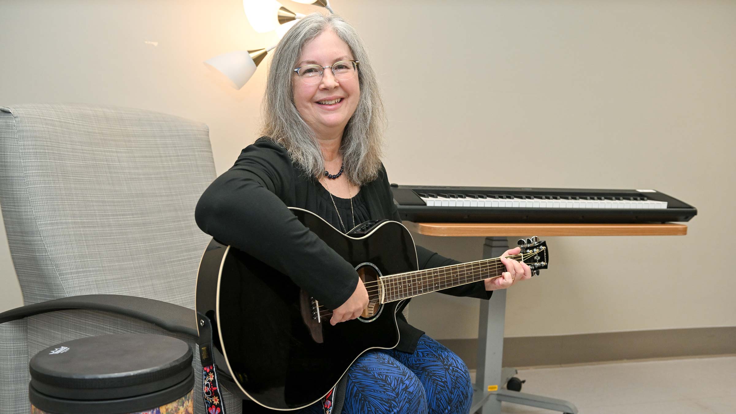 Ohio State music therapist, Pamilyn Richardson, with a guitar at Dodd Hall