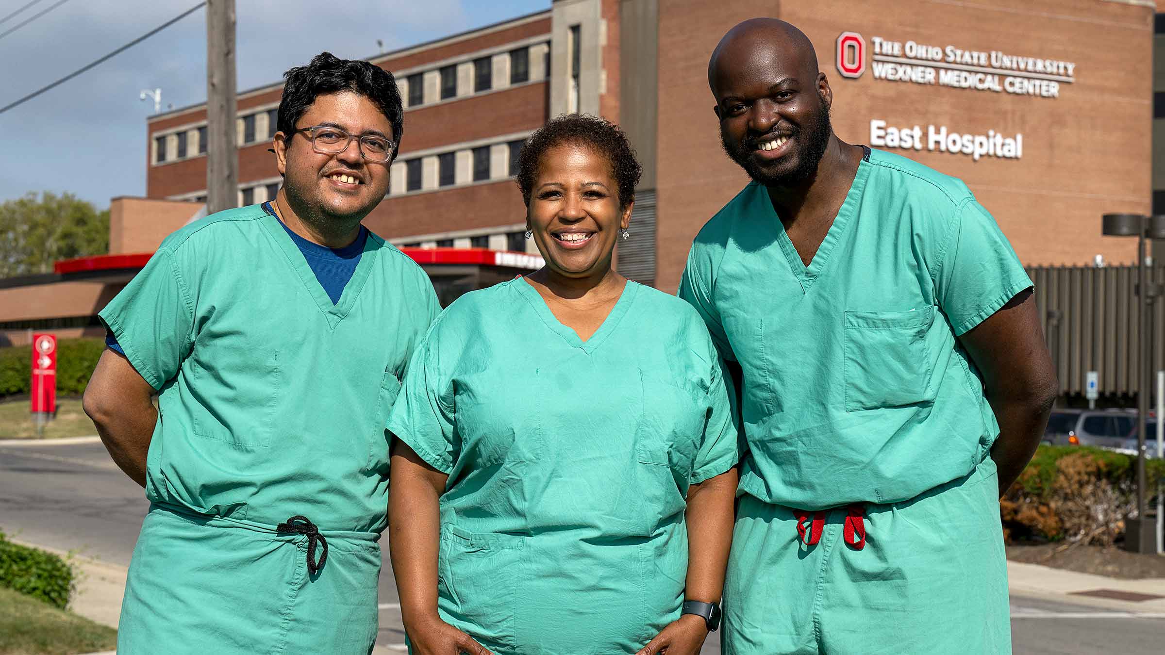 Three doctors with East Hospital on the background