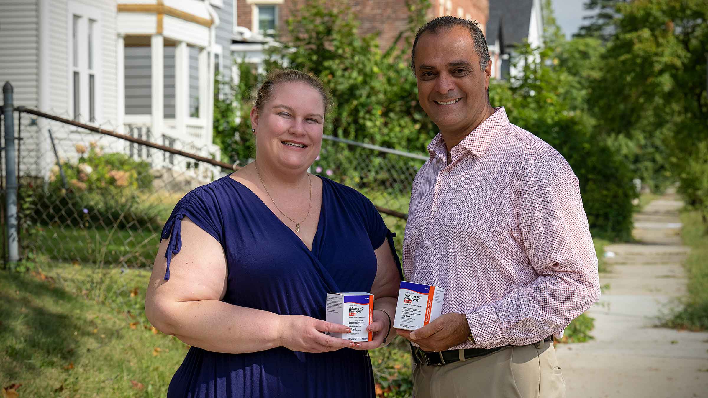 Julie Teater and Mohamad Moinzadeh holding Naloxone boxes
