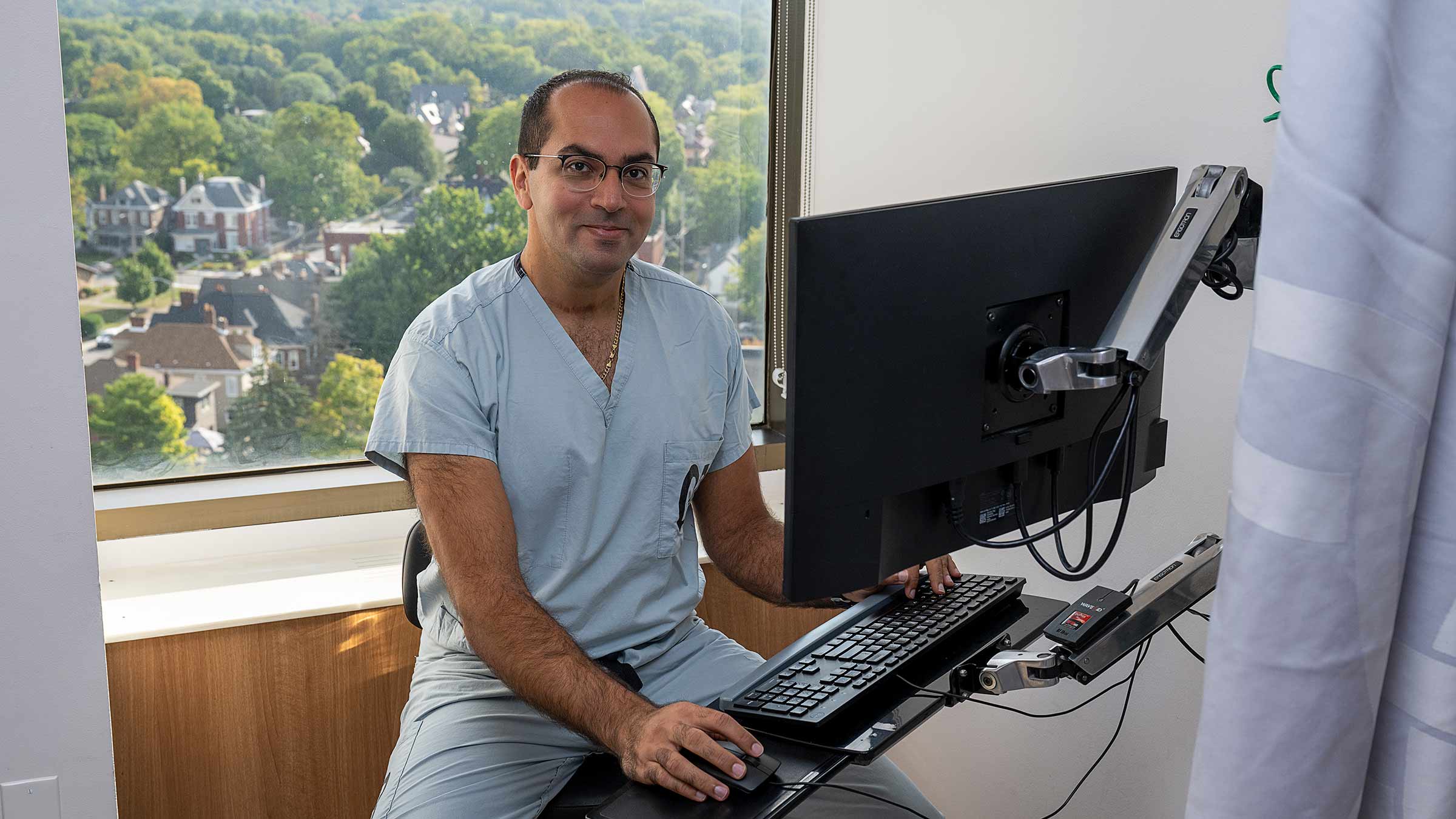 Michael Sourial, MD, in front of a computer
