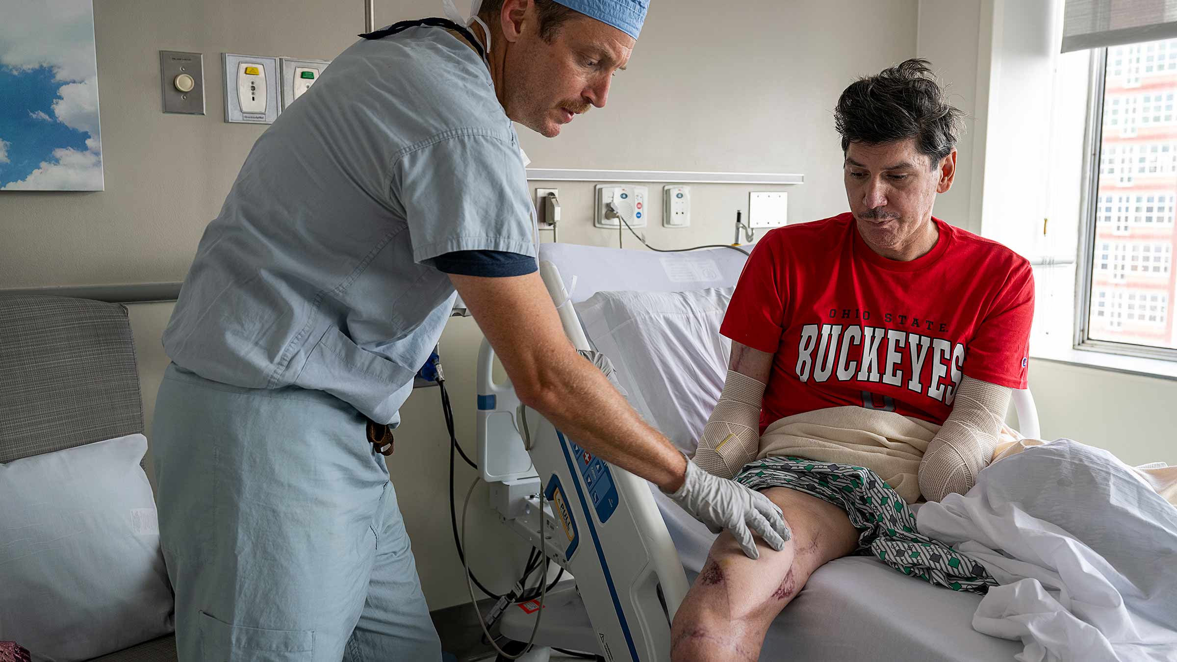 Dr. Souza checking on Ron Rosas' progress in a hospital room